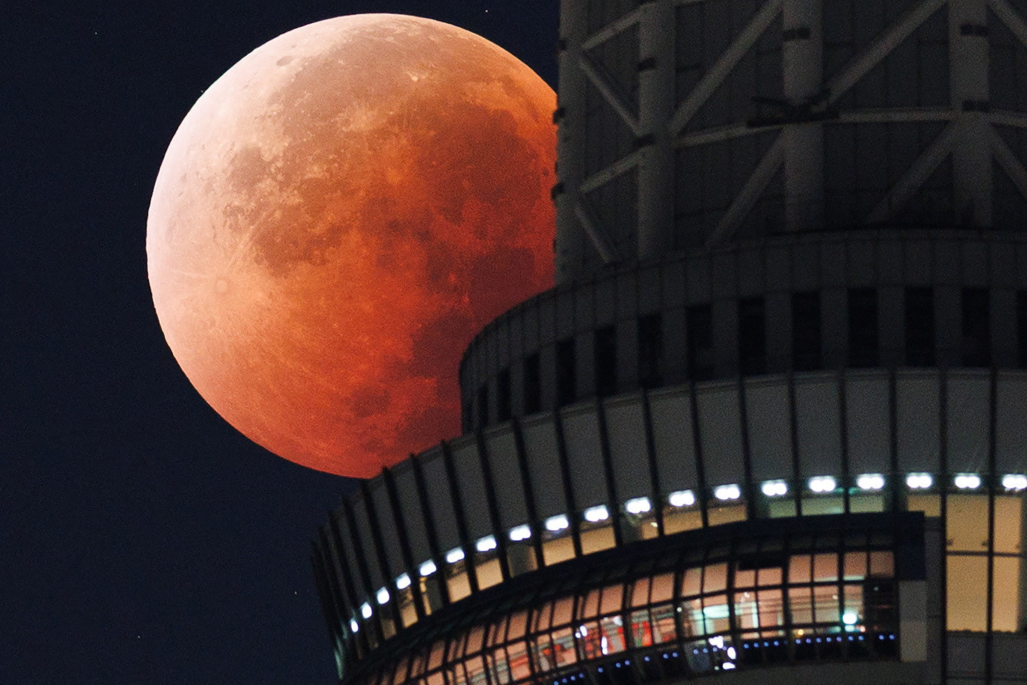 The Moon appears from behind the Tokyo Skytree during a total lunar eclipse