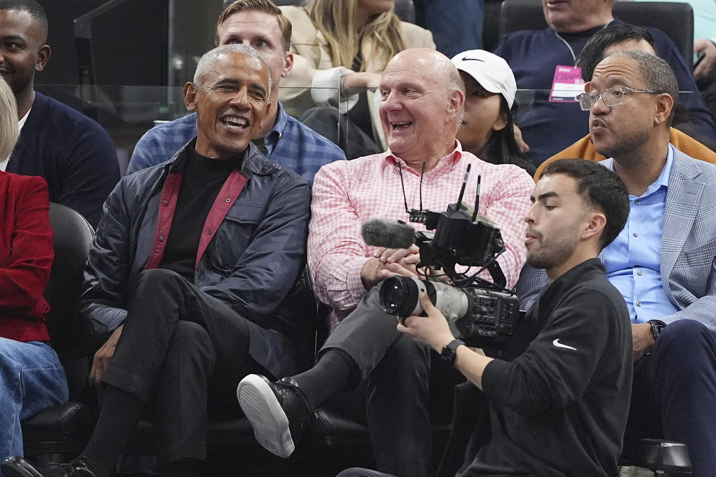 Former Microsoft CEO and majority shareholder Steve Ballmer, centre, sitting with former US President Barack Obama, left, at a Los Angeles Clippers game