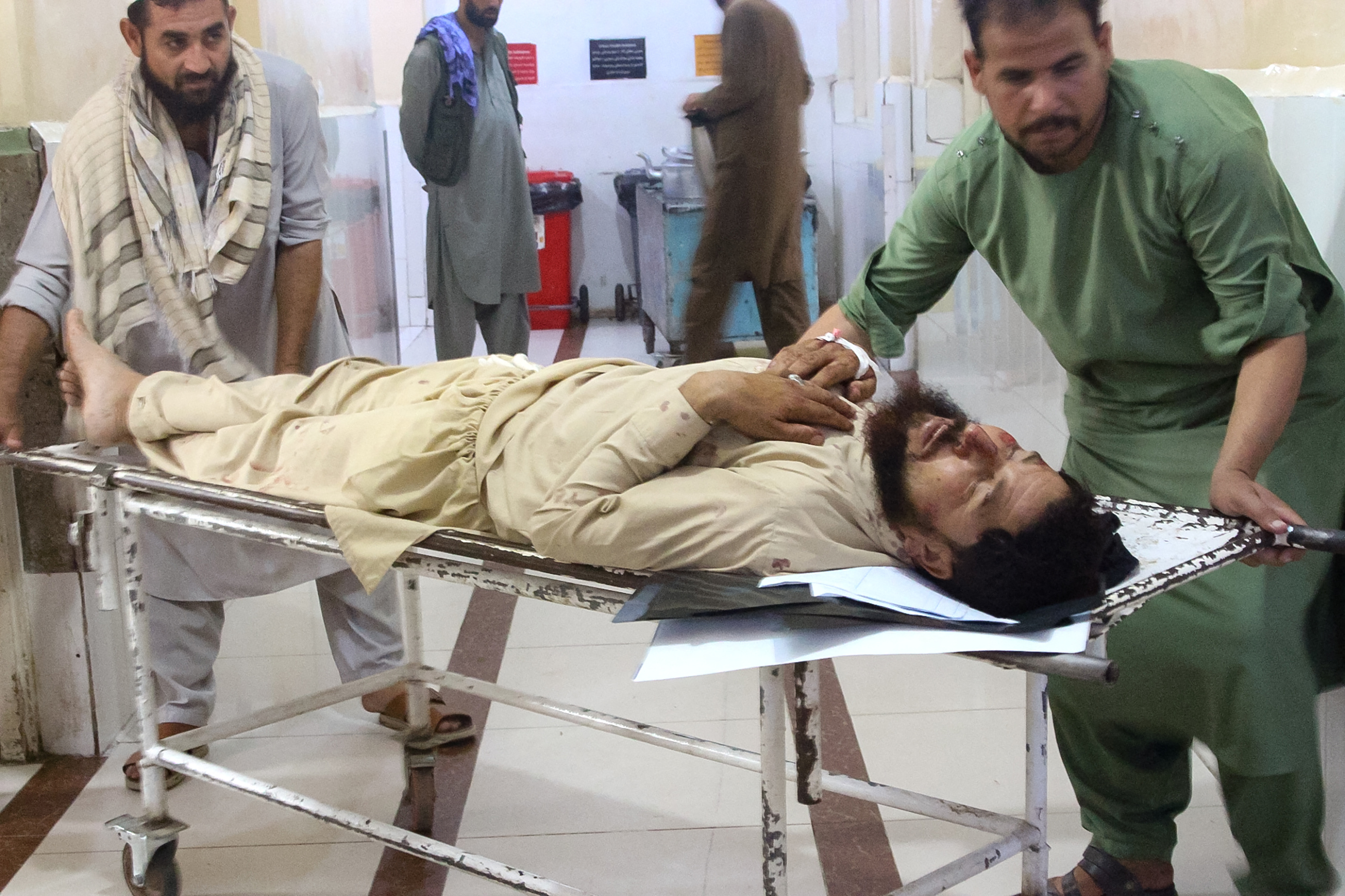 Volunteers carry an injured man to a hospital after an earthquake in Afghanistan's Jalalabad on September 1, 2025.