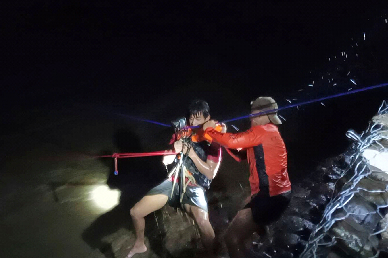 A man is rescued from a swollen river.