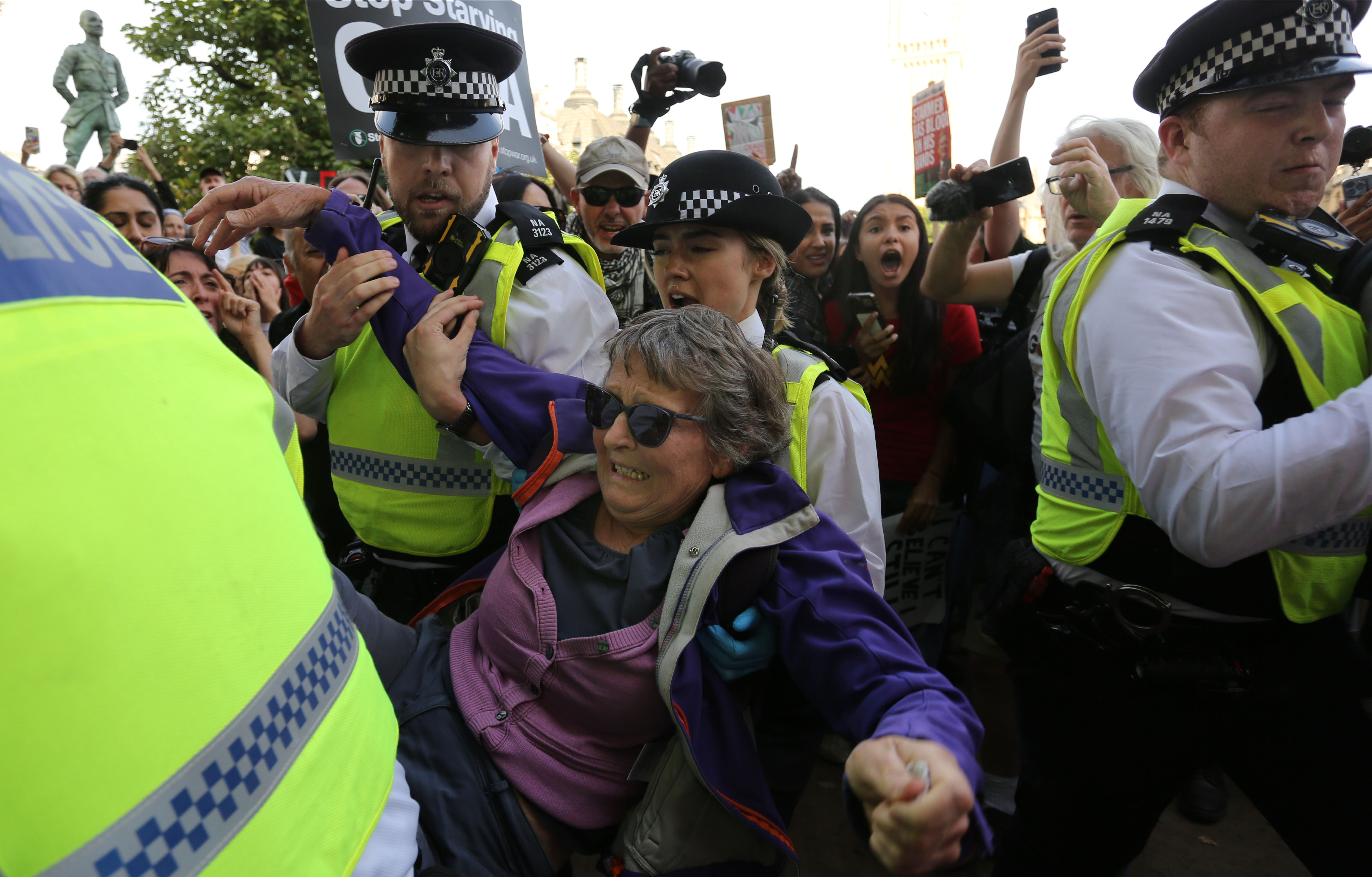 LONDON, ENGLAND - SEPTEMBER 6: A protester is arrested for holding up a sign saying 'I oppose Genocide - I support Palestine Action' during the protest in Parliament Square on September 6, 2025 in London, England. The UK Government will be able to challenge the decision to allow activist group Palestine Action's appeal against their proscription as a terrorist organisation. (Photo by Martin Pope/Getty Images)