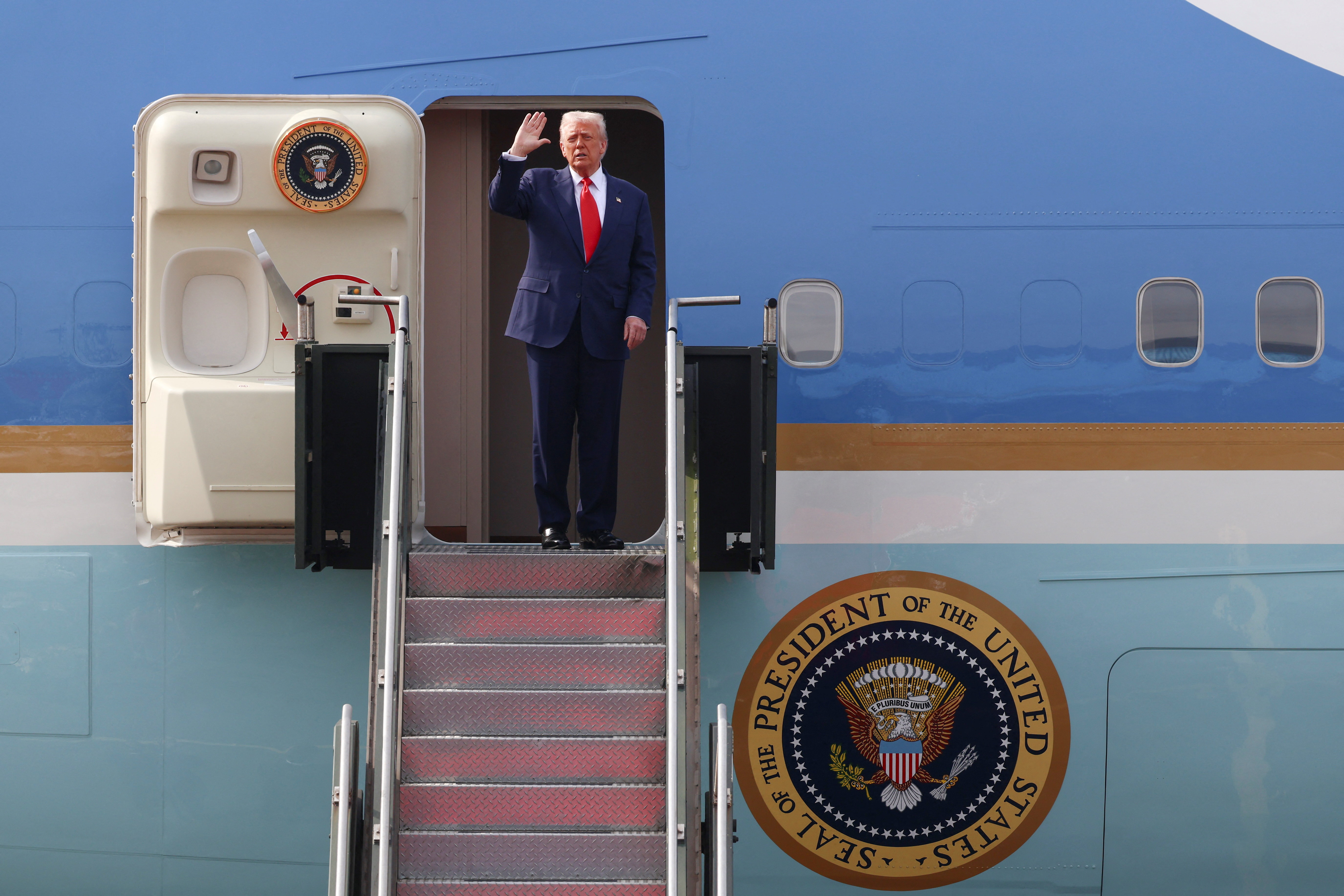 U.S. President Donald Trump gestures as he boards Air Force One at Gimhae International Airport in Busan, South Korea, October 30, 2025.
