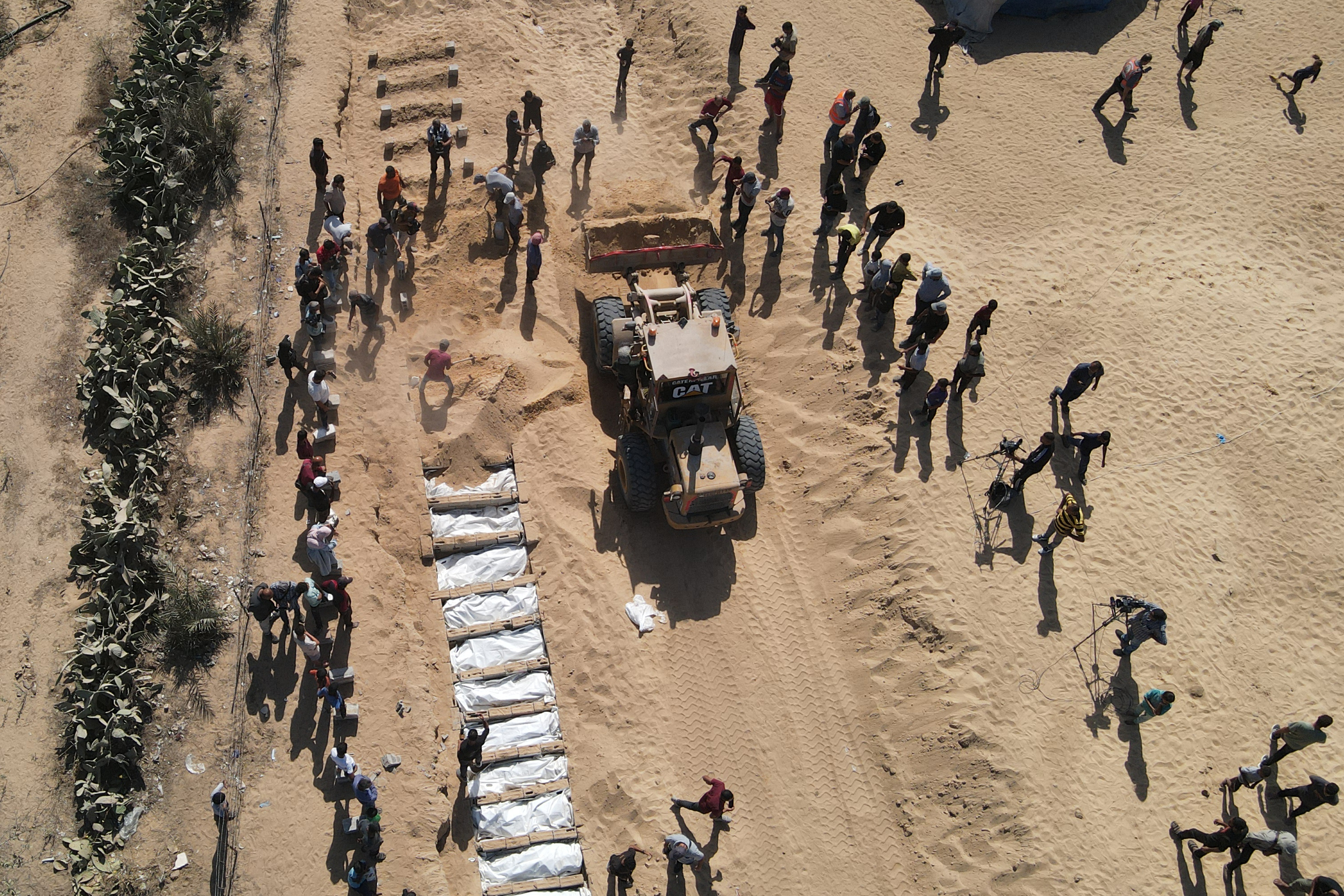 Families mourn as mass burial held for unidentified Palestinians in Gaza
