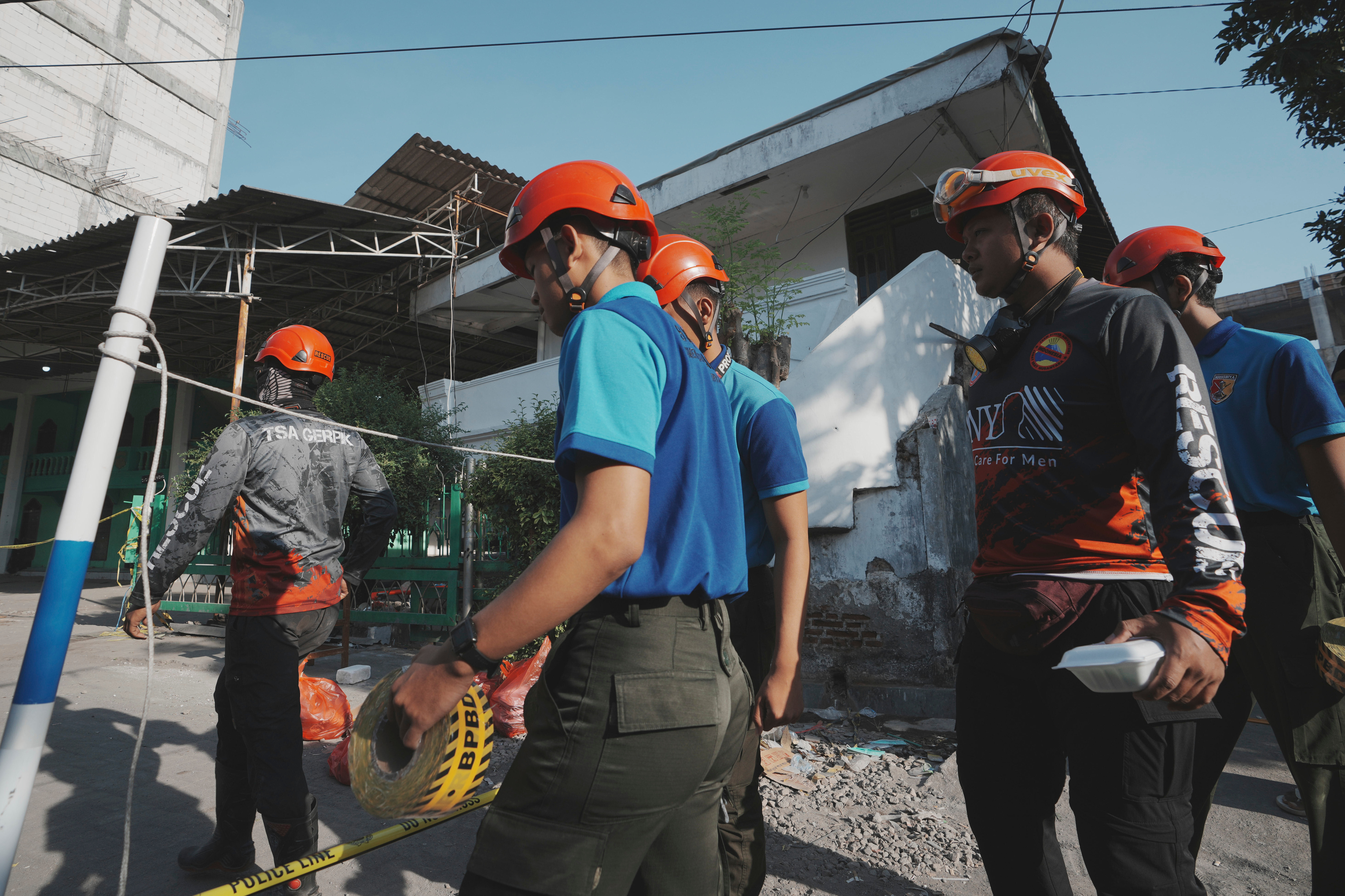 Rescuers walk to the site where a building under construction collapsed at a boarding school in Sidoarjo, East Java, Indonesia