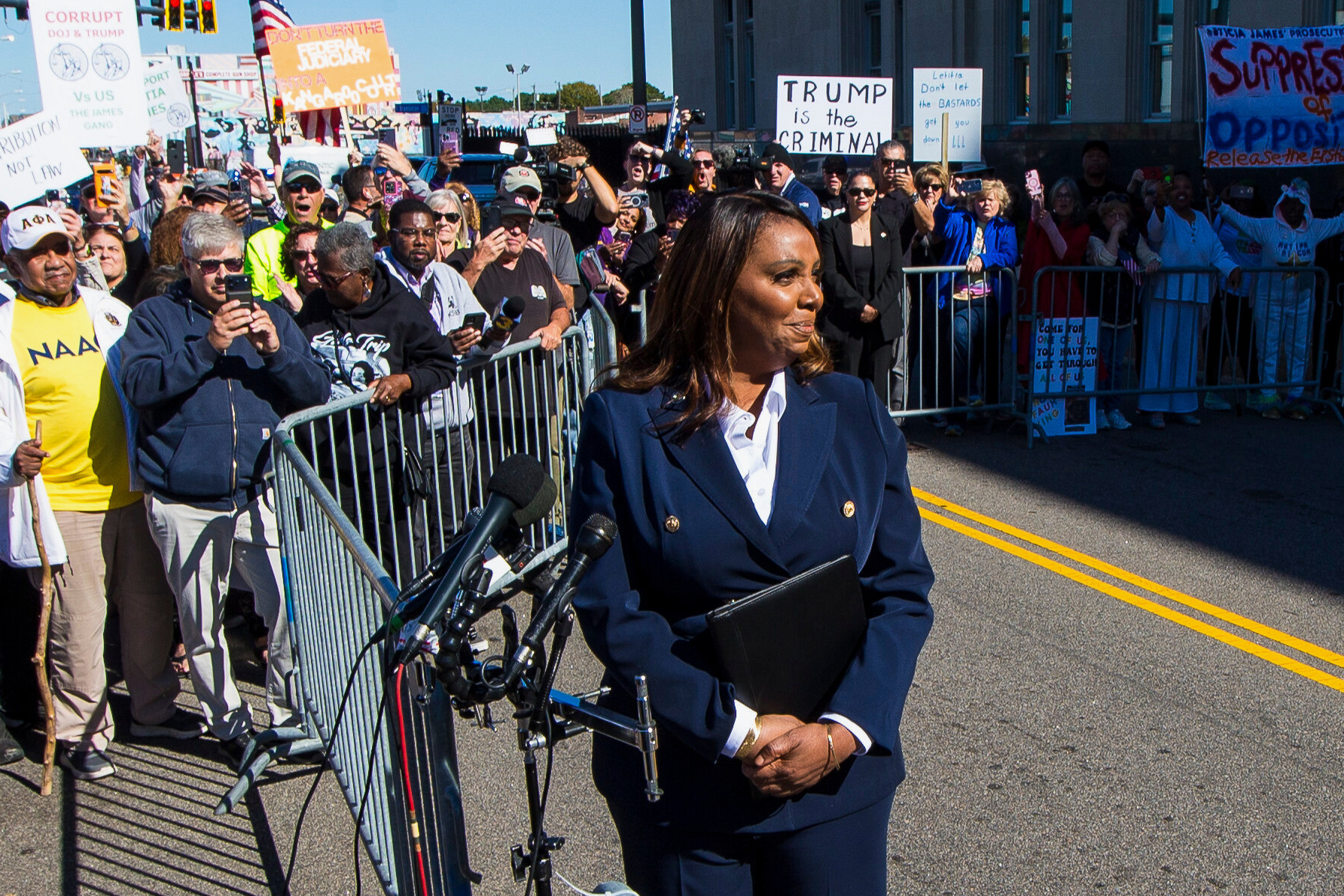 Letitia James speaks to a crowd outside a federal courtroom.