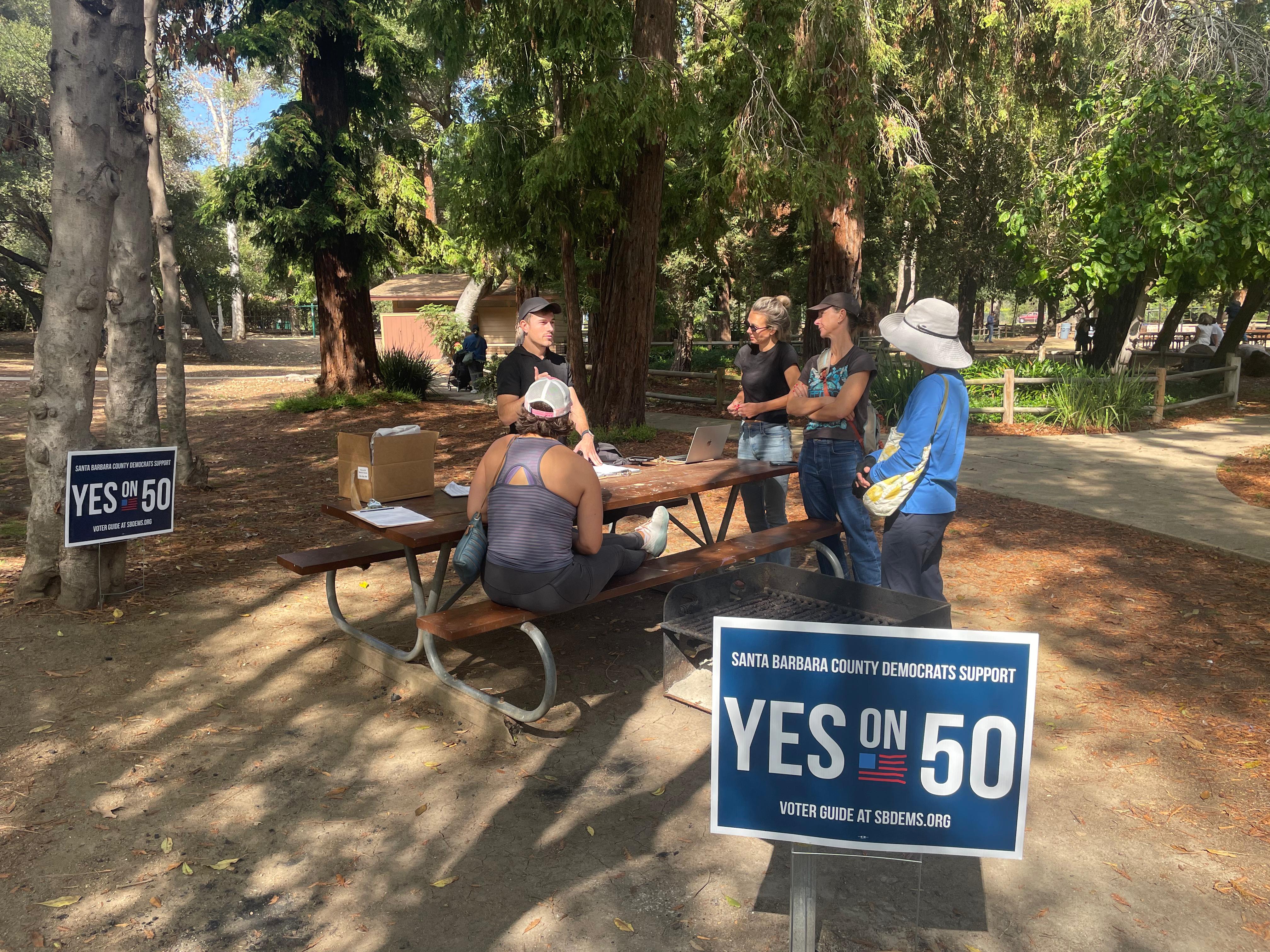 Volunteers meet in a park before canvassing in support of Proposition 50 in California