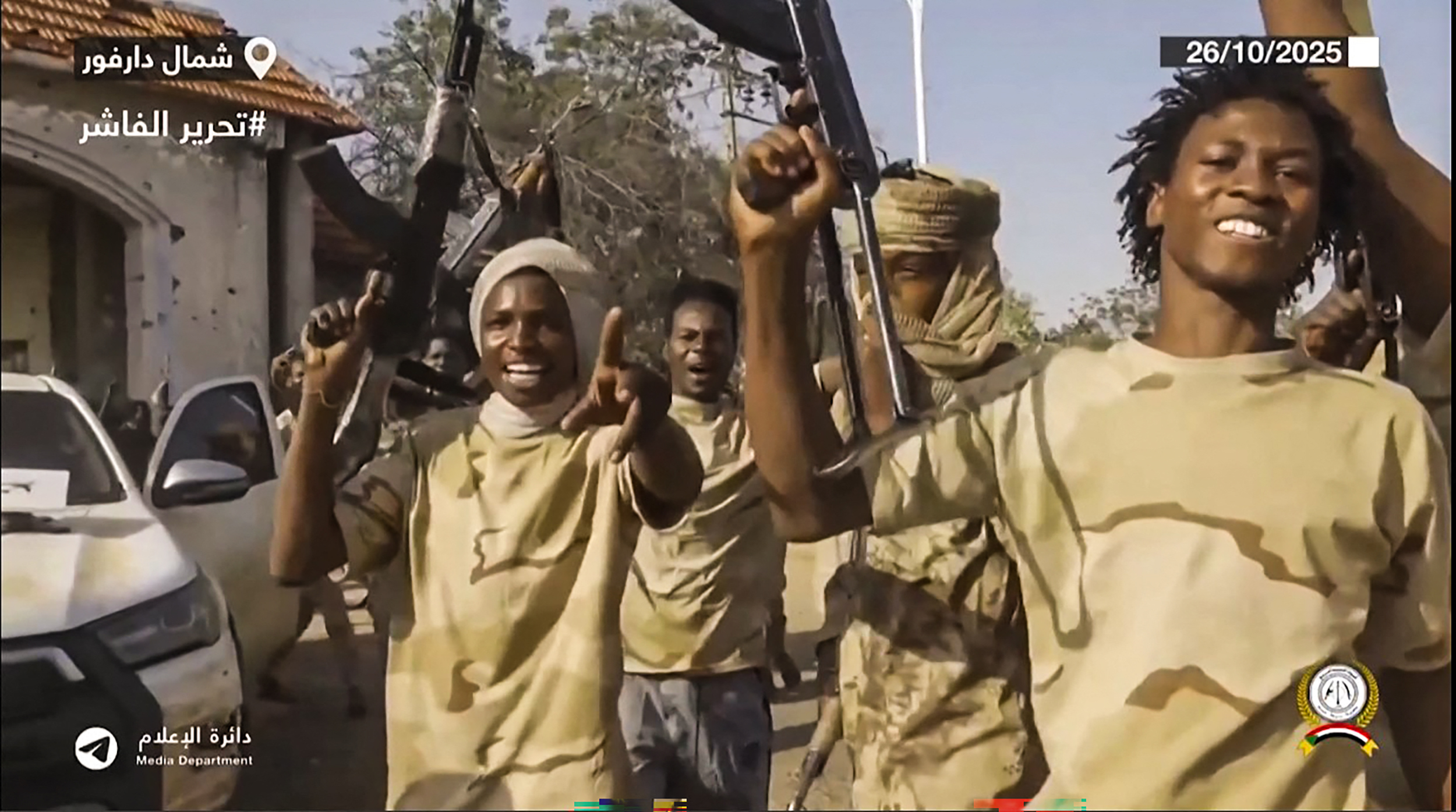 This image grab taken from handout video footage released on Sudan's paramilitary Rapid Support Forces (RSF) Telegram account on October 26, 2025, shows RSF fighters holding weapons and celebrating in the streets of El-Fasher in Sudan's Darfur.