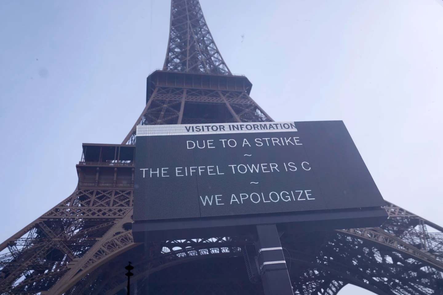 A board at the closed Eiffel Tower during a new round of strikes and protests to denounce spending cuts and demand higher taxes on the rich [Michel Euler/AP]