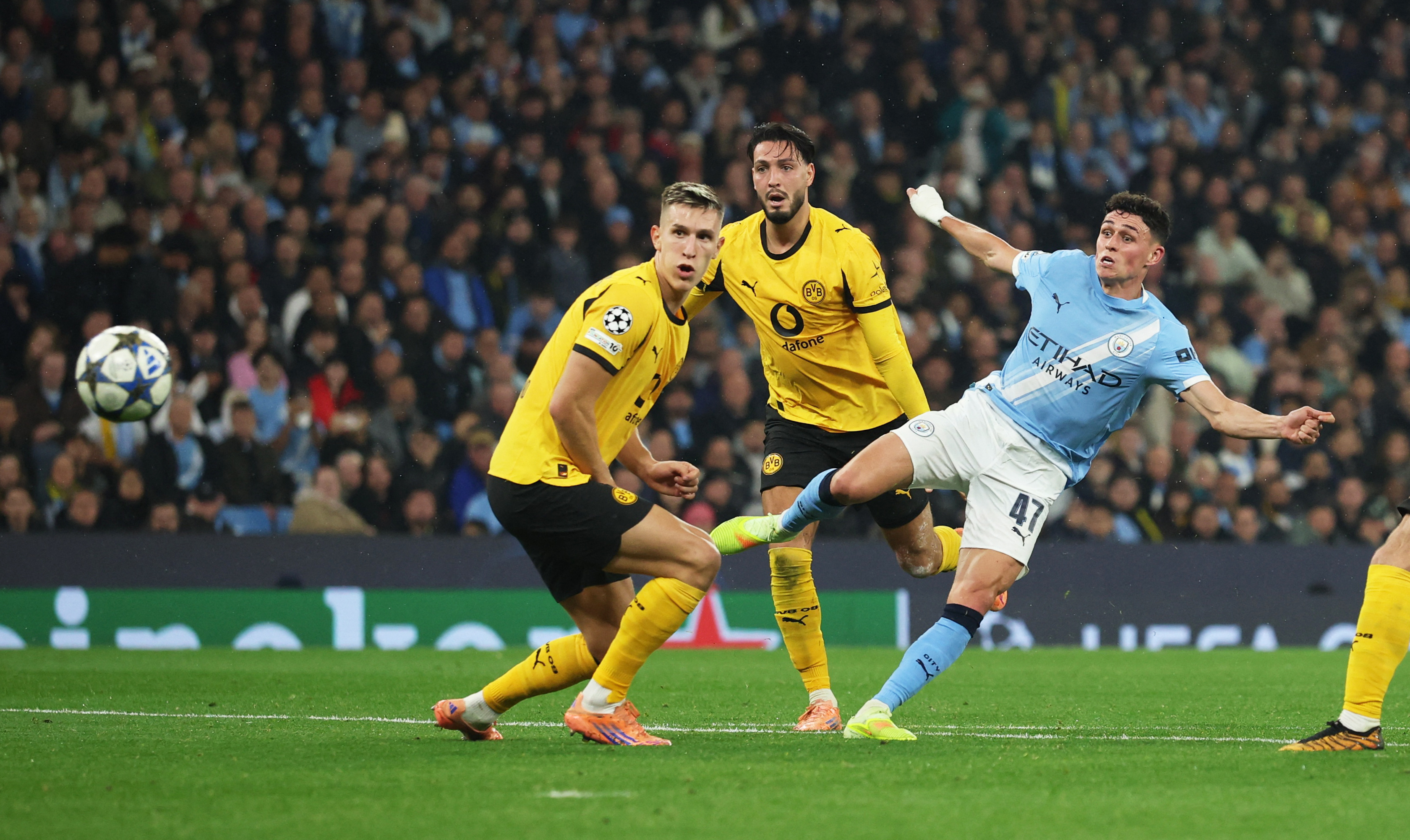 Foden, right, scores Manchester City’s third goal in the 57th minute