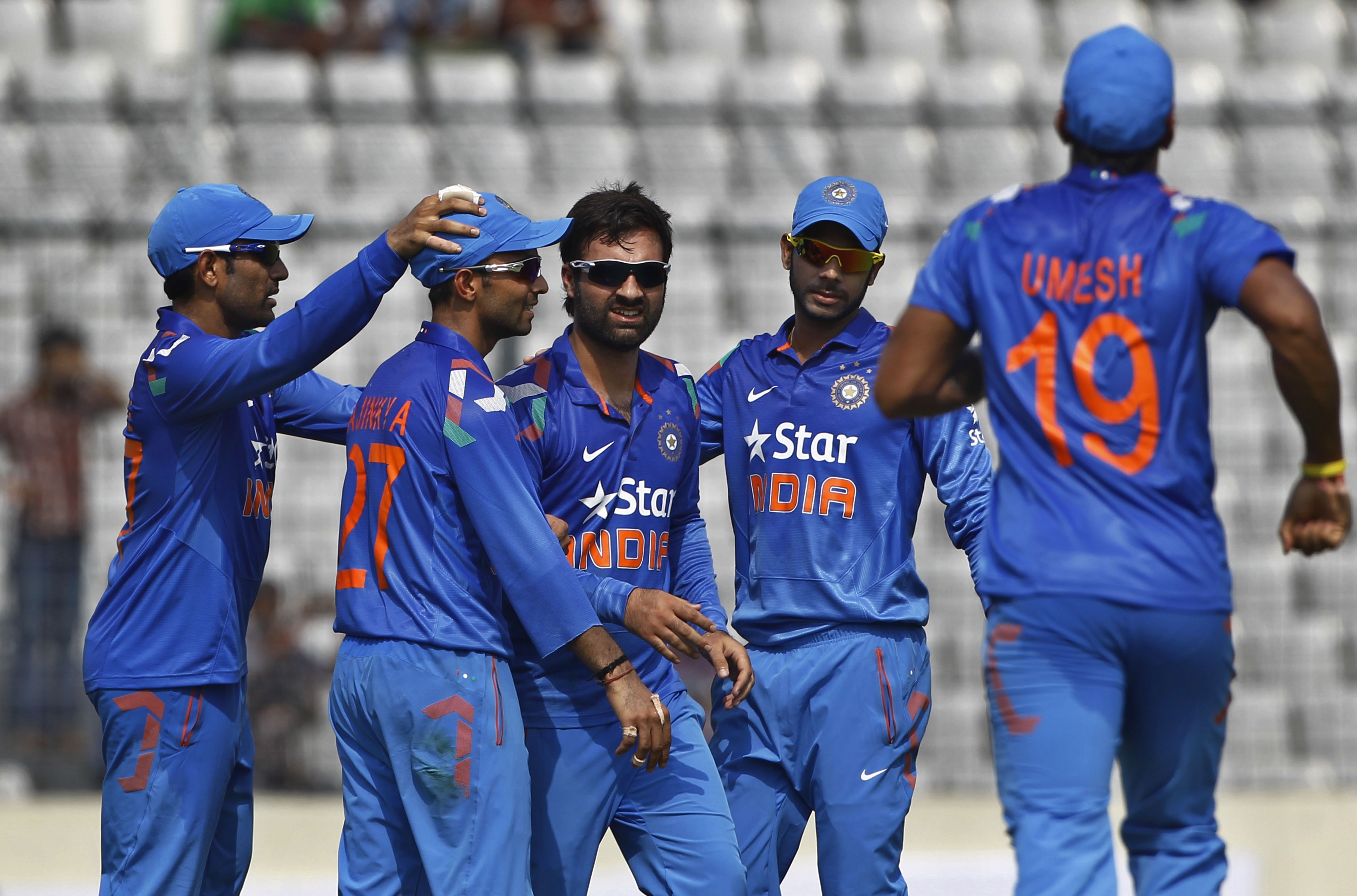 India's Parvez Rasool, center, celebrates with his teammates the wicket of Bangladeshs captain Mushfiqur Rahim during their first one-day International cricket match in Dhaka, Bangladesh, Sunday, June 15, 2014. (AP Photo/A.M. Ahad)