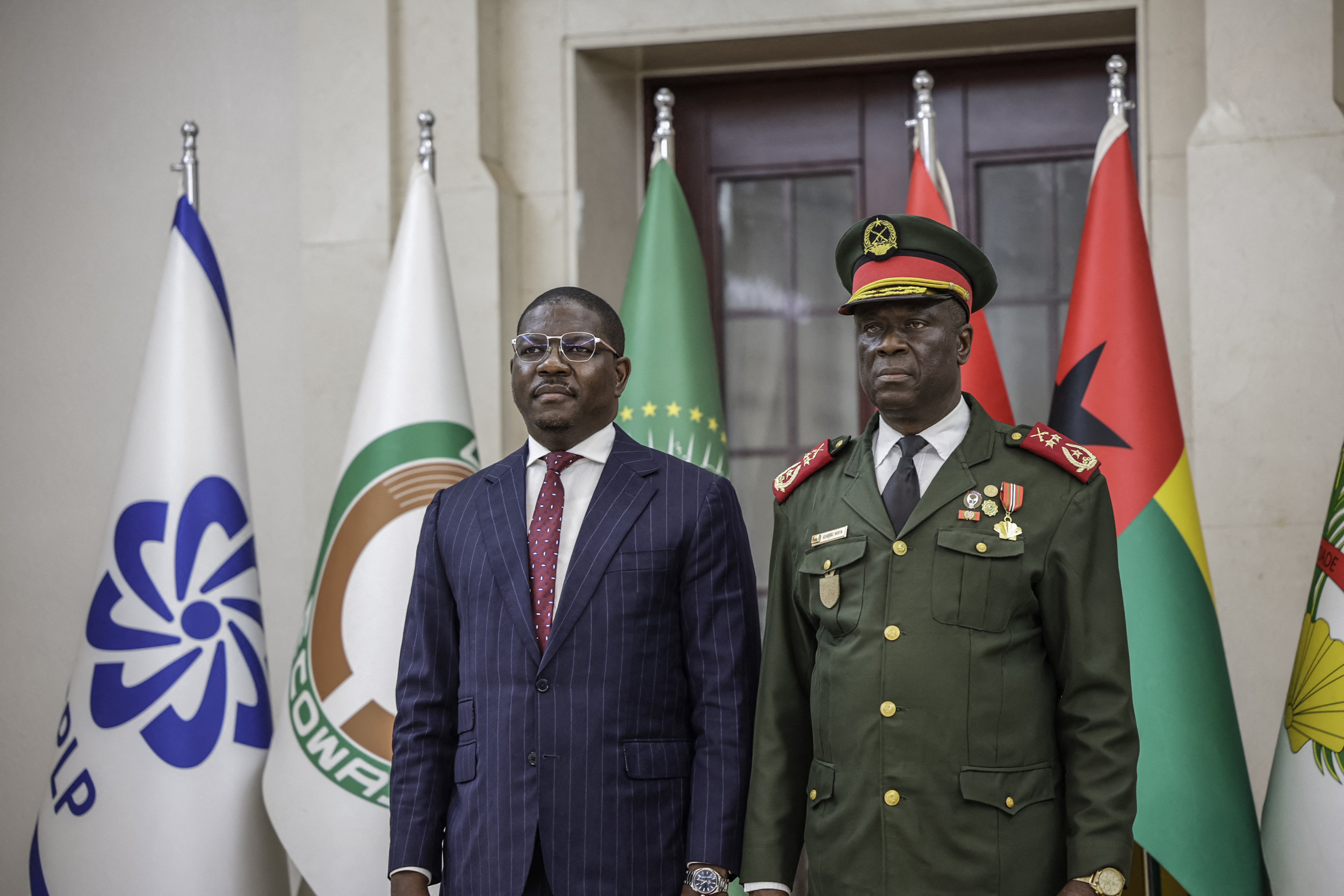 Guinea Bissau newly appointed Prime Minister and Finance Minister of the transitional government Ilidio Vieira Te (L) looks on as he stands next to the transitional government President, General Horta N'Tam during the swearing in ceremony at the Presidential Palace in Bissau, on November 28, 2025.