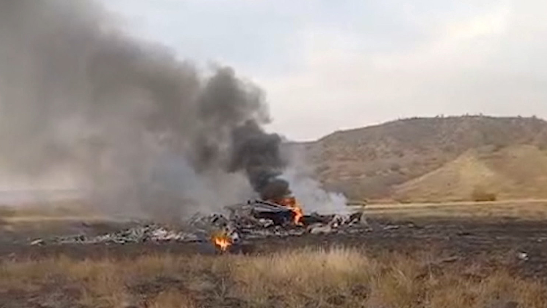 Smoke rises above wreckage at the site of the Turkish C-130 military cargo plane crash near the Azerbaijani border, in Sighnaghi municipality, Georgia, on Nov. 11, 2025, in this still image taken from video. [TV Imedi/Reuters]