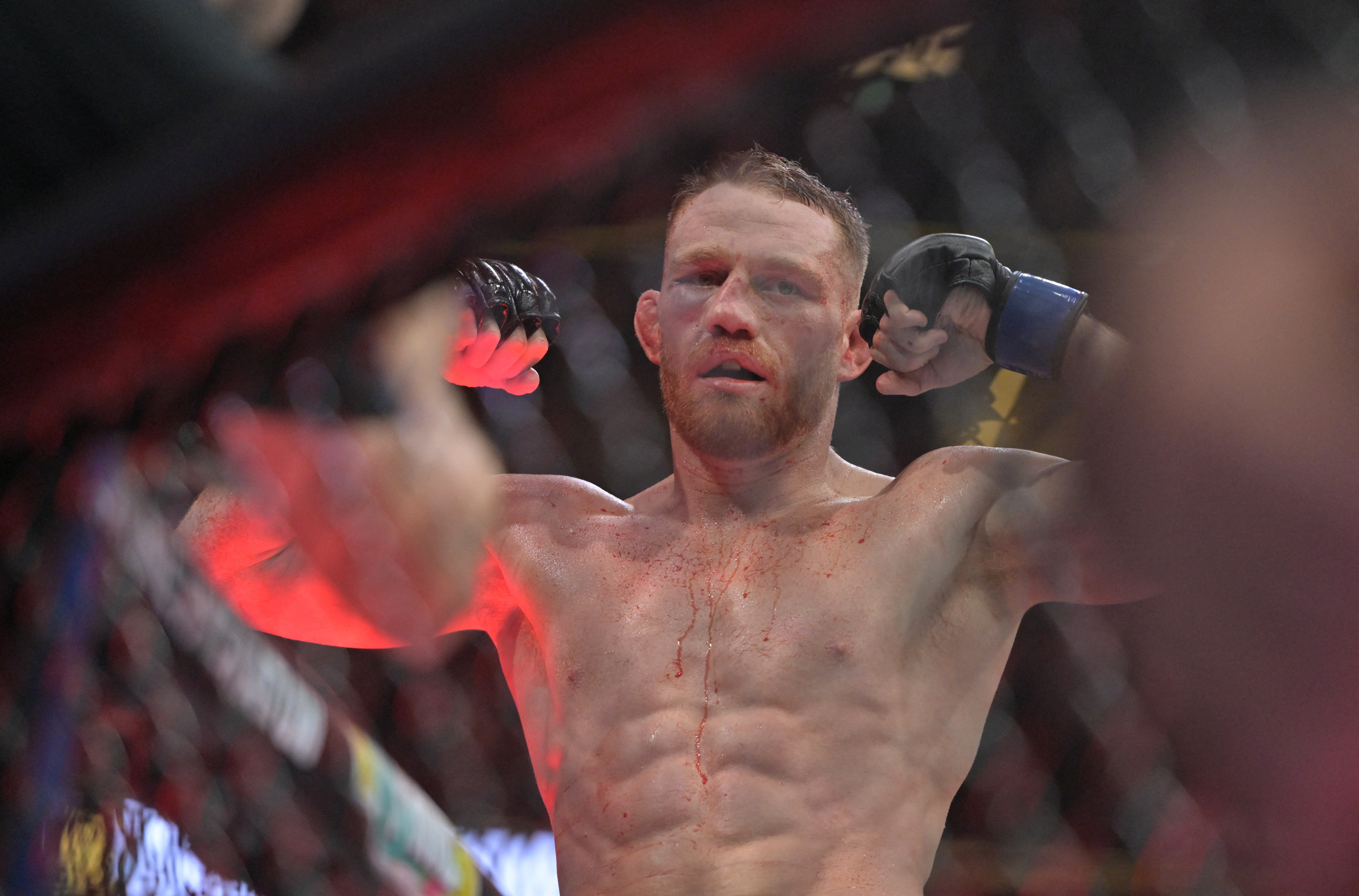 Jack Della Maddalena (blue gloves) reacts after defeating Belal Muhammad (not pictured).