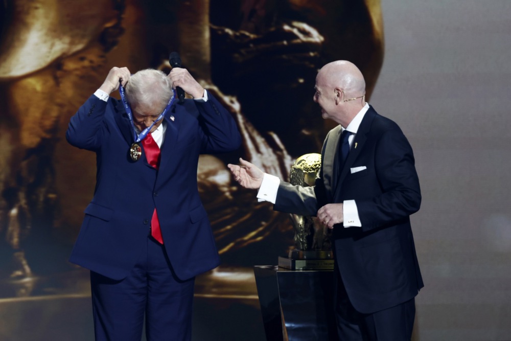epa12578393 US President Donald Trump (L) receives the FIFA Peace Prize from FIFA President Gianni Infantino during the FIFA World Cup 2026 Final Draw at the Kennedy Center in Washington DC, USA, 05 December 2025. EPA/WILL OLIVER