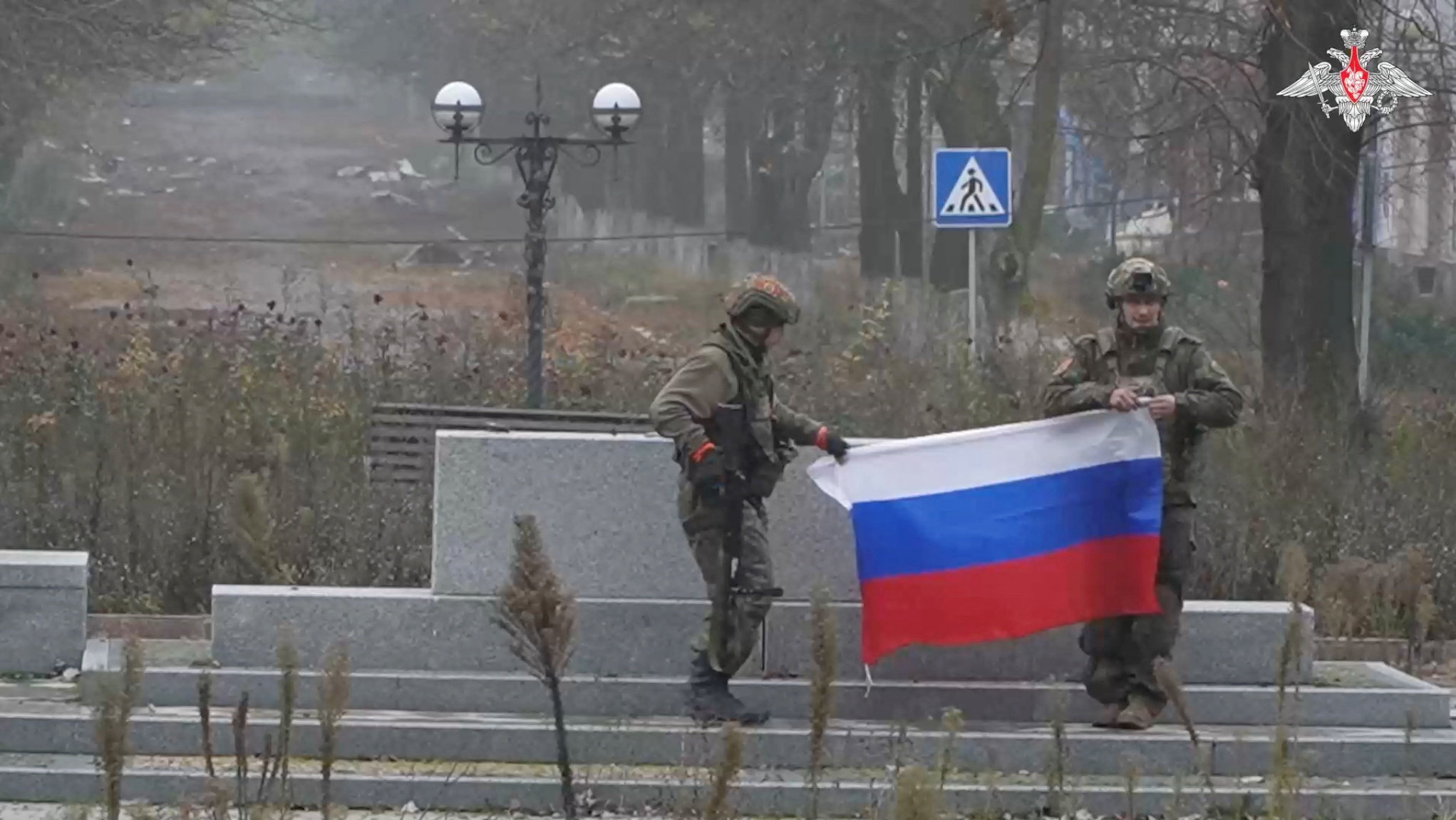 A soldier holds a Russian flag in Pokrovsk, Donetsk Region, Ukraine, in this screengrab from video released December 1, 2025 [Handout: Russian Defence Ministry via Reuters]