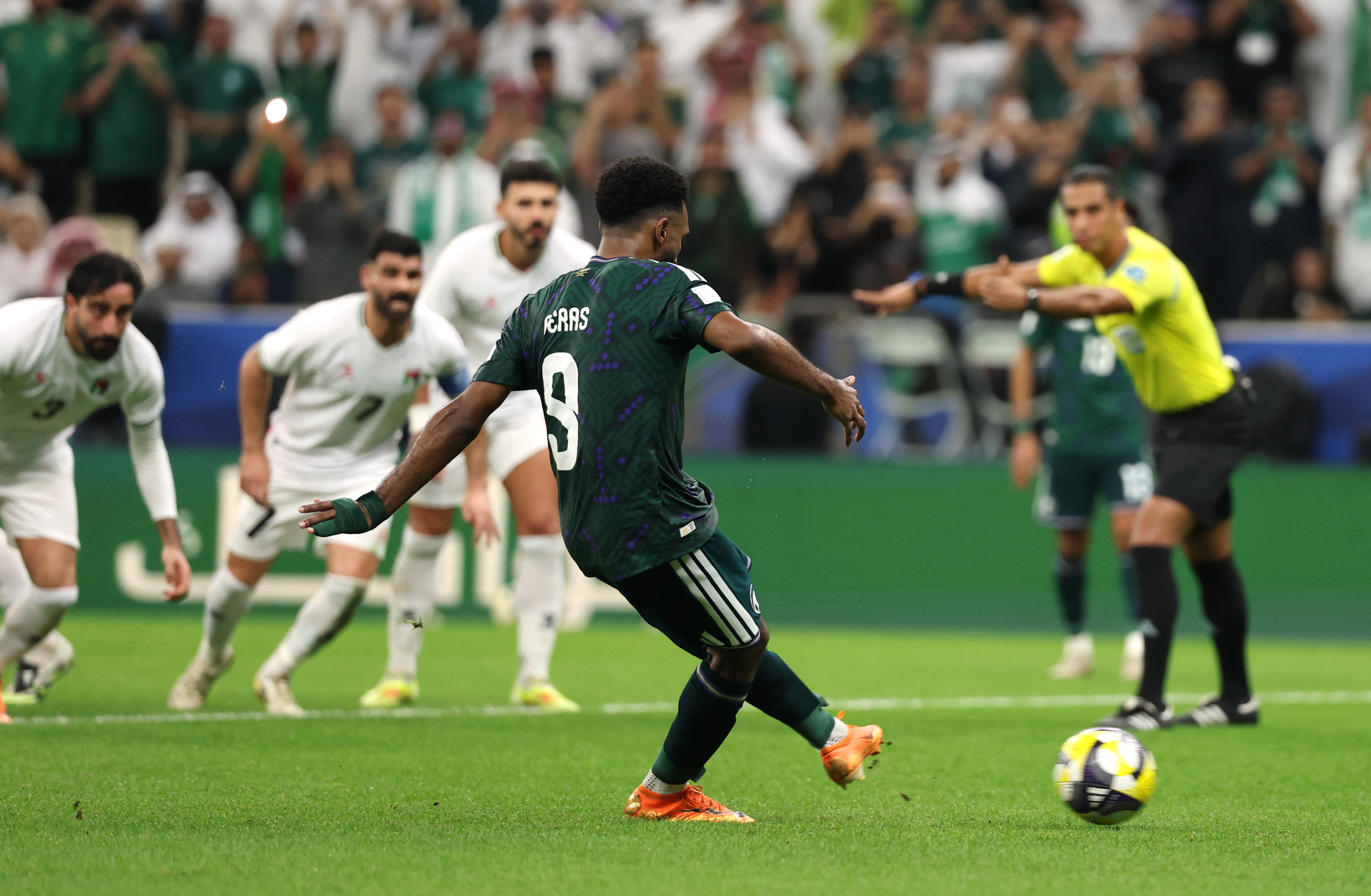 Saudi Arabia's Firas Al Buraikan scores their first goal from the penalty spot
