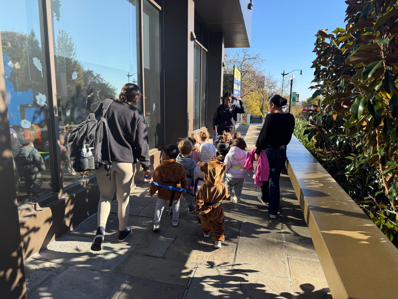 Kids walk along a Washington, DC, sidewalk outside CommuniKids