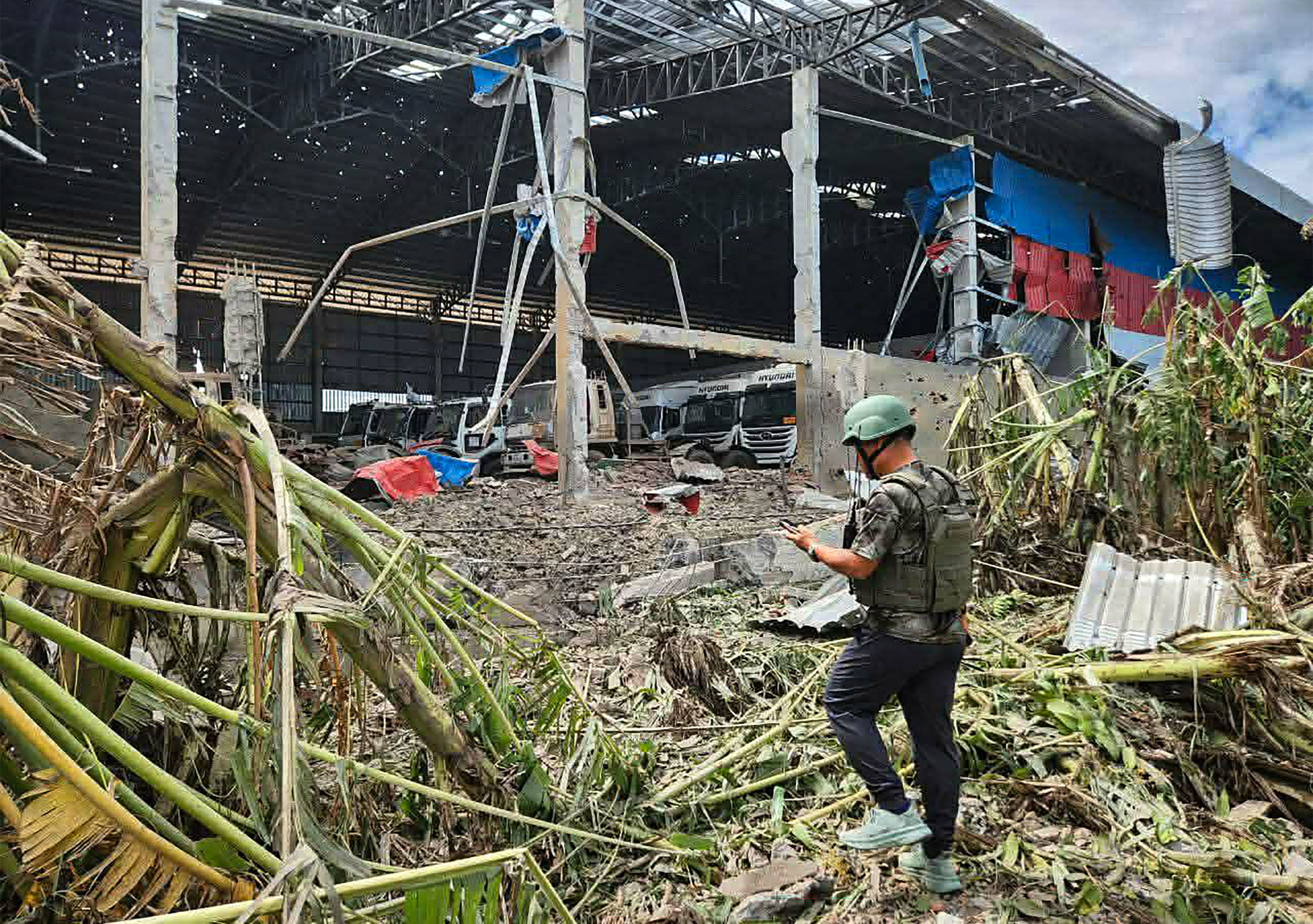 A man inspects a garage damaged after Thai air attacks in Poipet town, Banteay Meanchey province