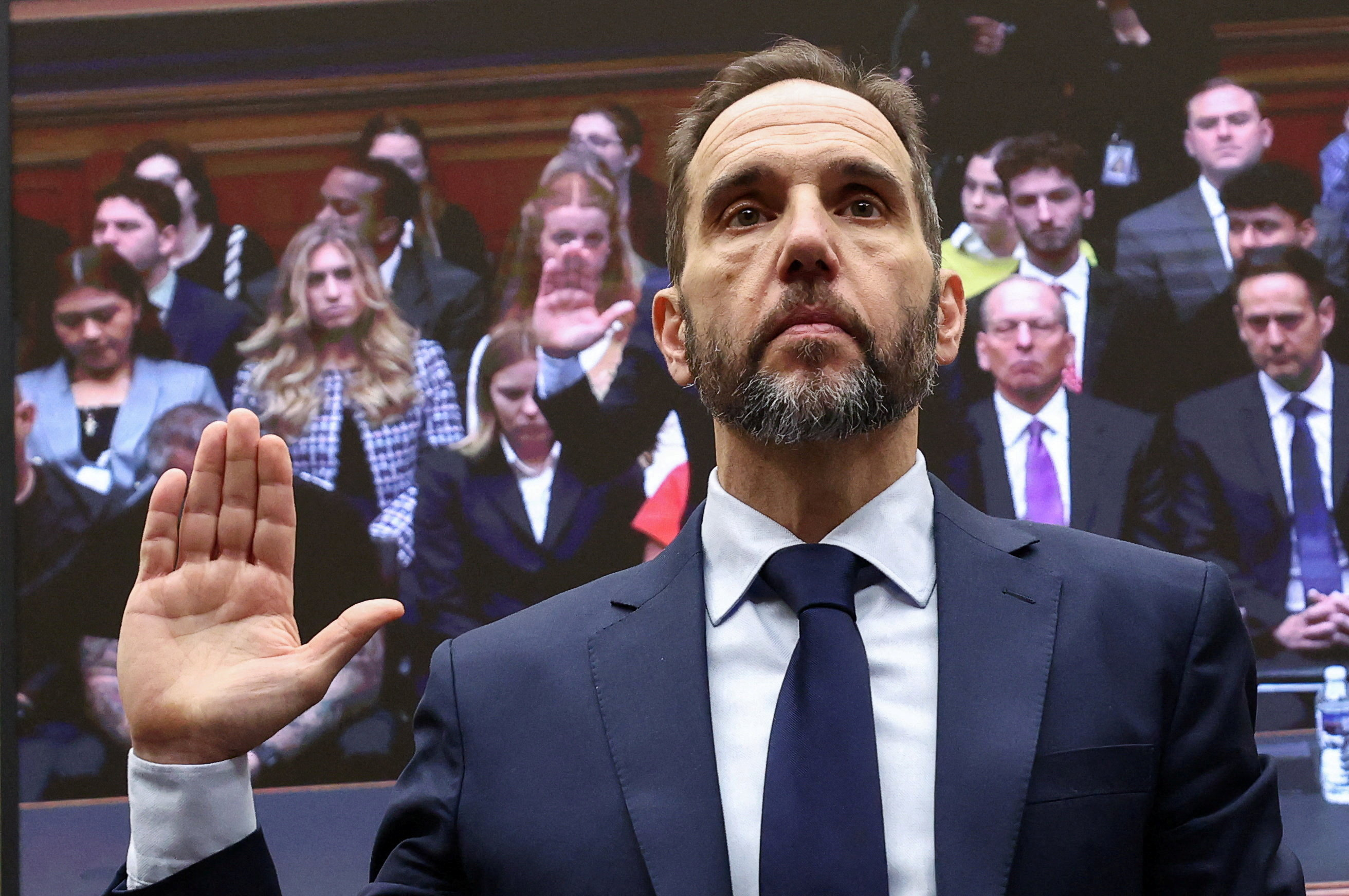 Former Special Counsel Jack Smith raises his hand to swear in, as he is to testify.