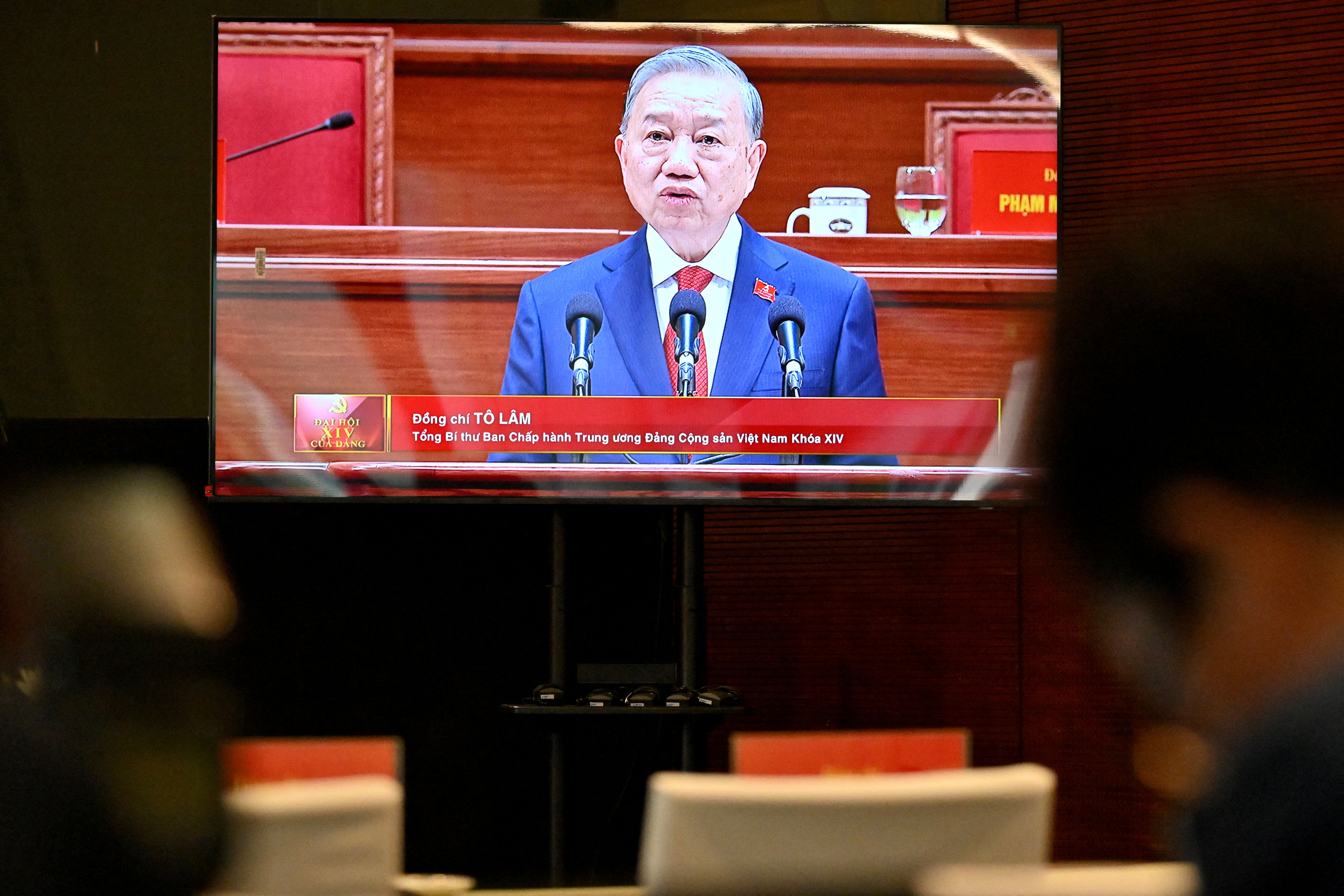 Vietnam's relected Communist Party General Secretary To Lam is seen on a screen as he speaks during the closing session of the Communist Party of Vietnam's (CPV) 14th National Congress at the National Convention Centre in Hanoi on January 23, 2026. Vietnam's Communist Party "unanimously" re-elected To Lam to the post of general secretary on January 23, it said on its website, confirming he will remain the country's top leader for the next five years. (Photo by Nhac NGUYEN / AFP