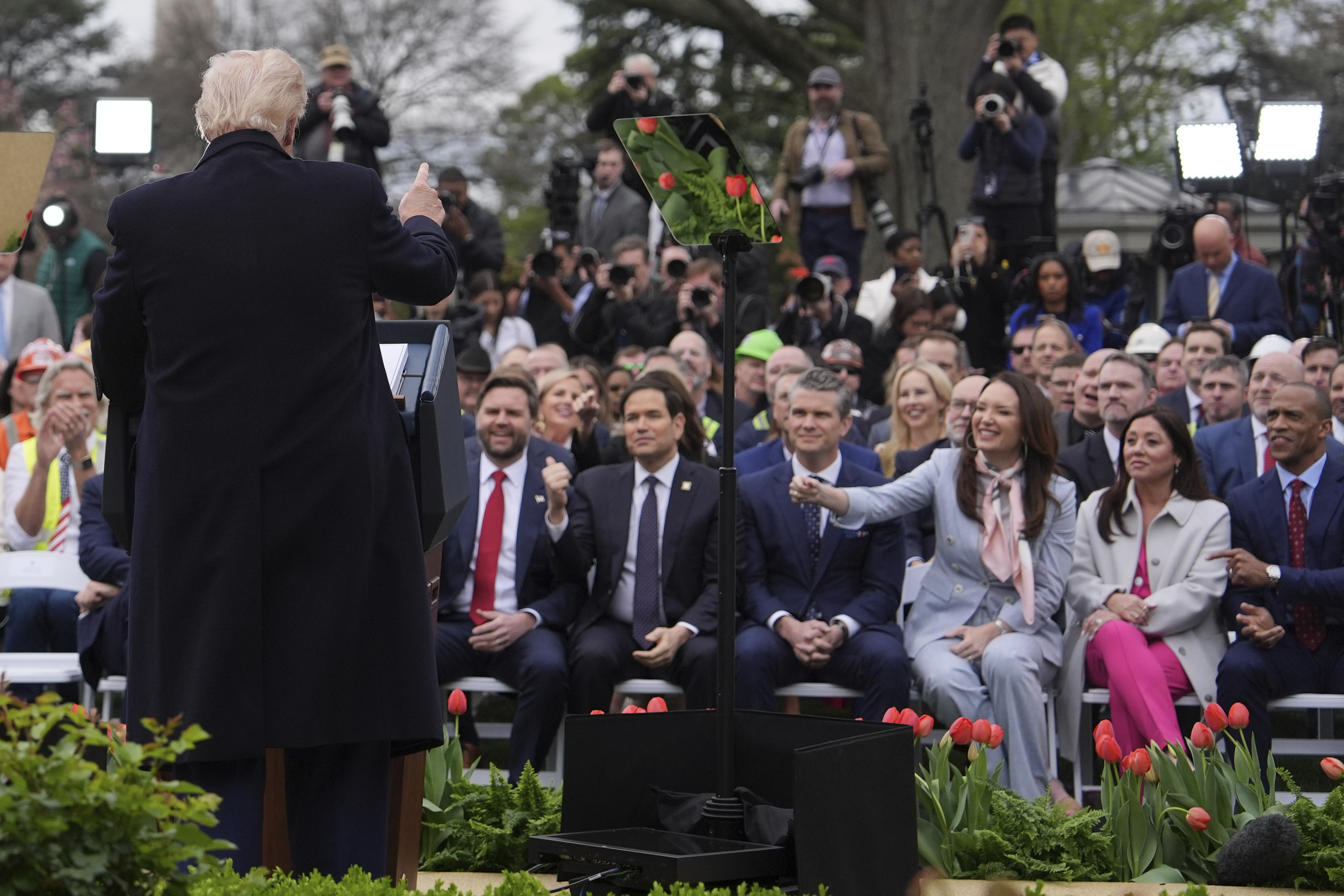 Trump speaks in front of a crowd at the Rose Garden