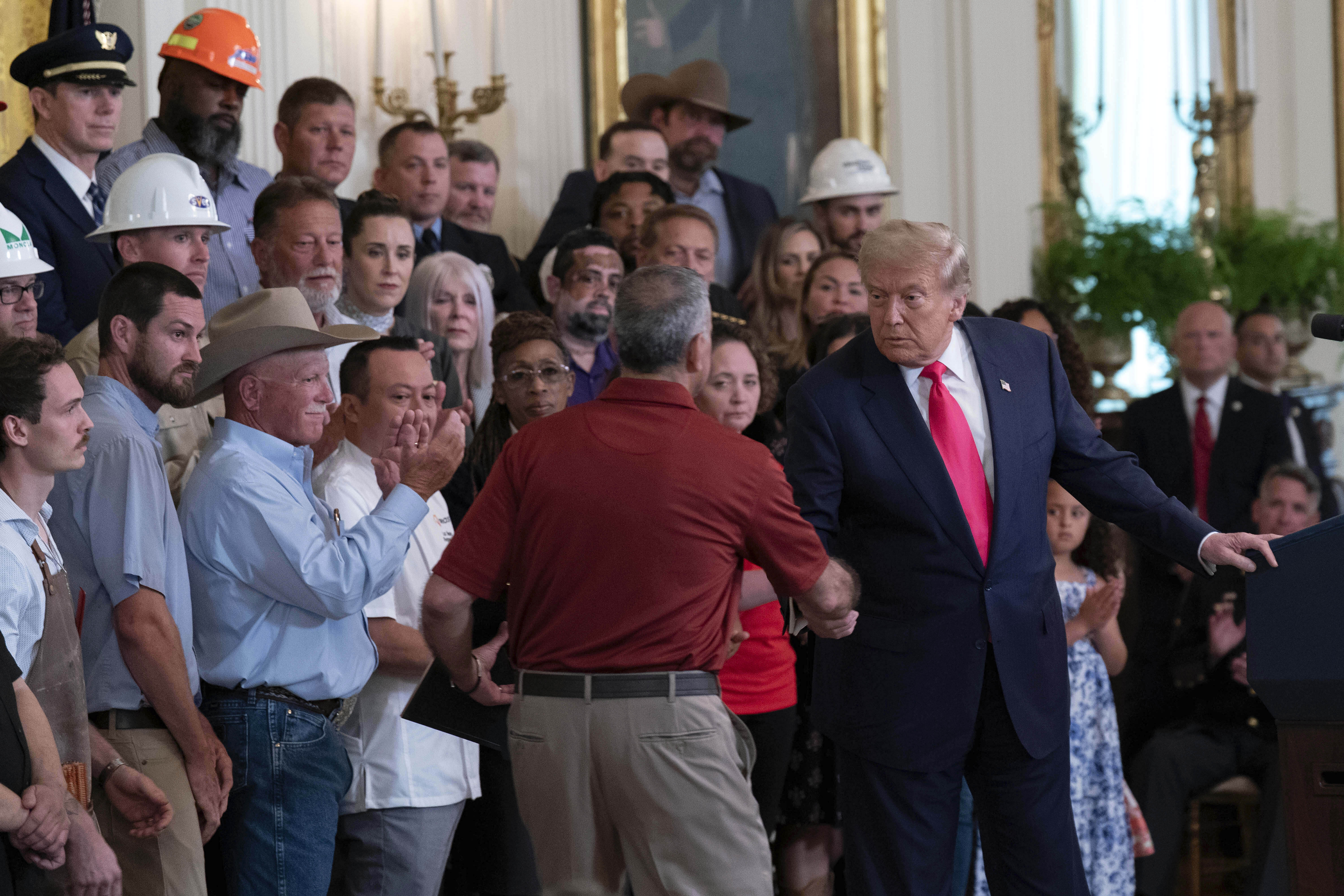 Trump shakes hands with Joe Abraham at a White House event