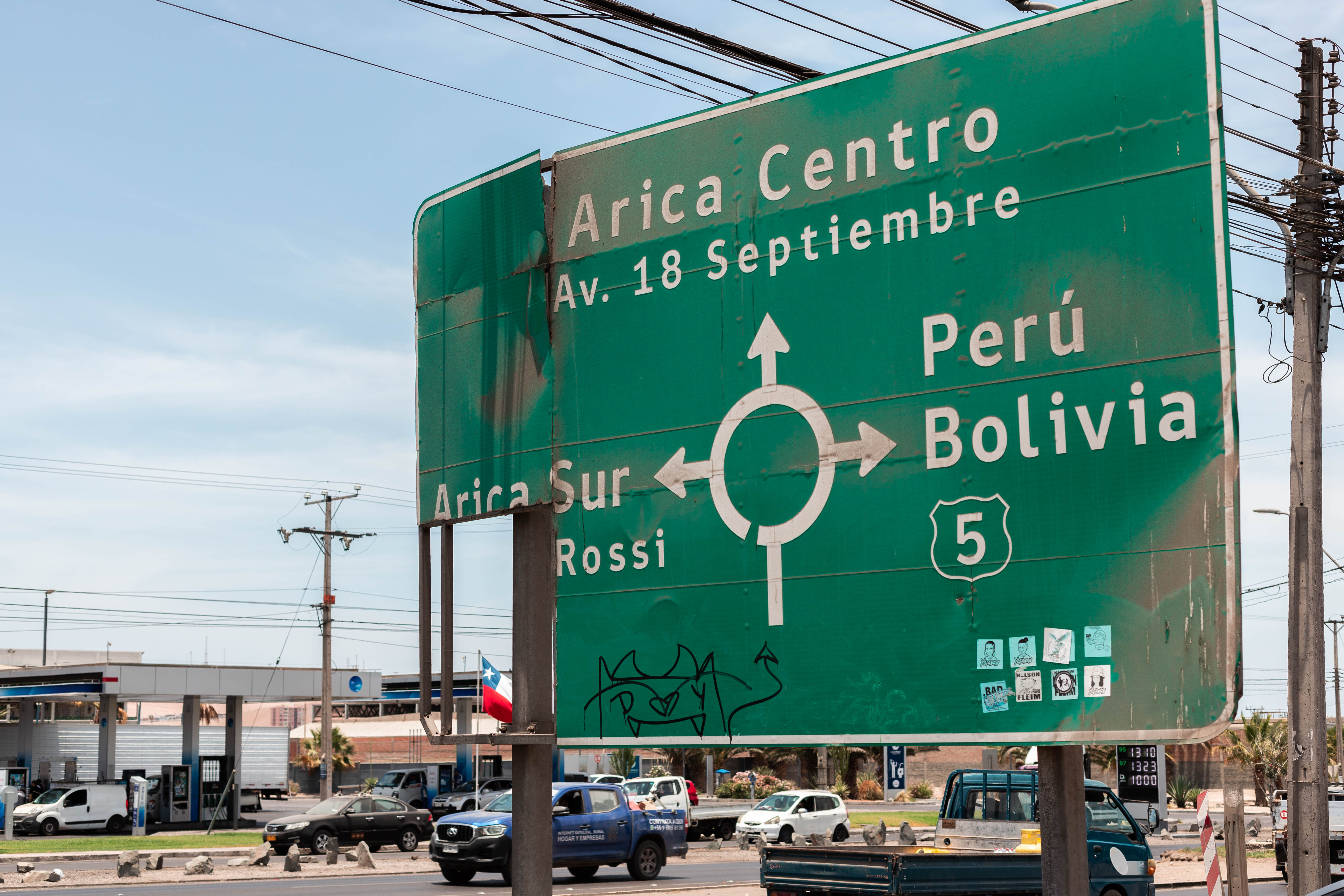 A road sign that points the way to Arica Centro, Peru and Bolivia