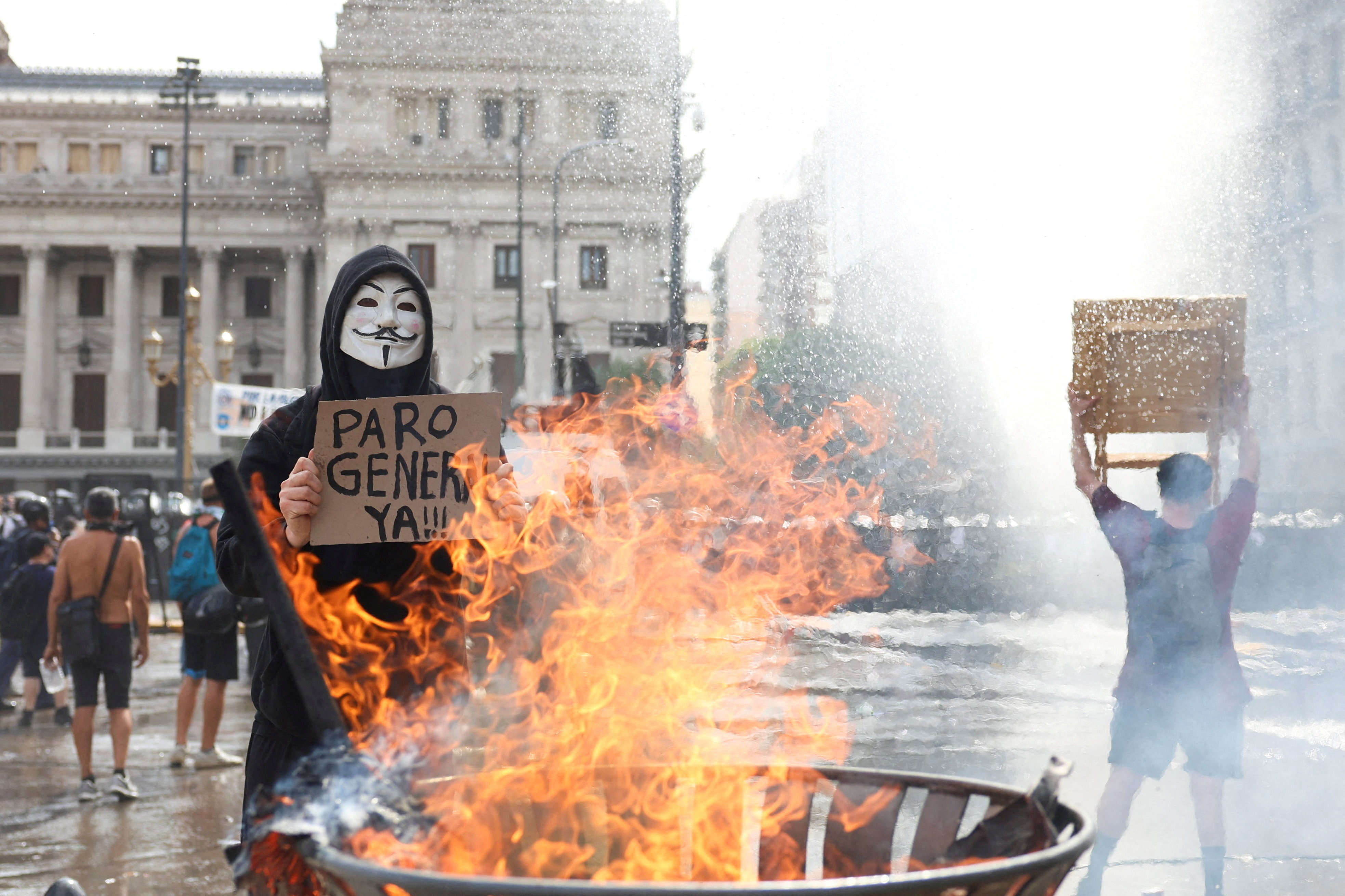 A demonstrator holds a sign calling for a general strike