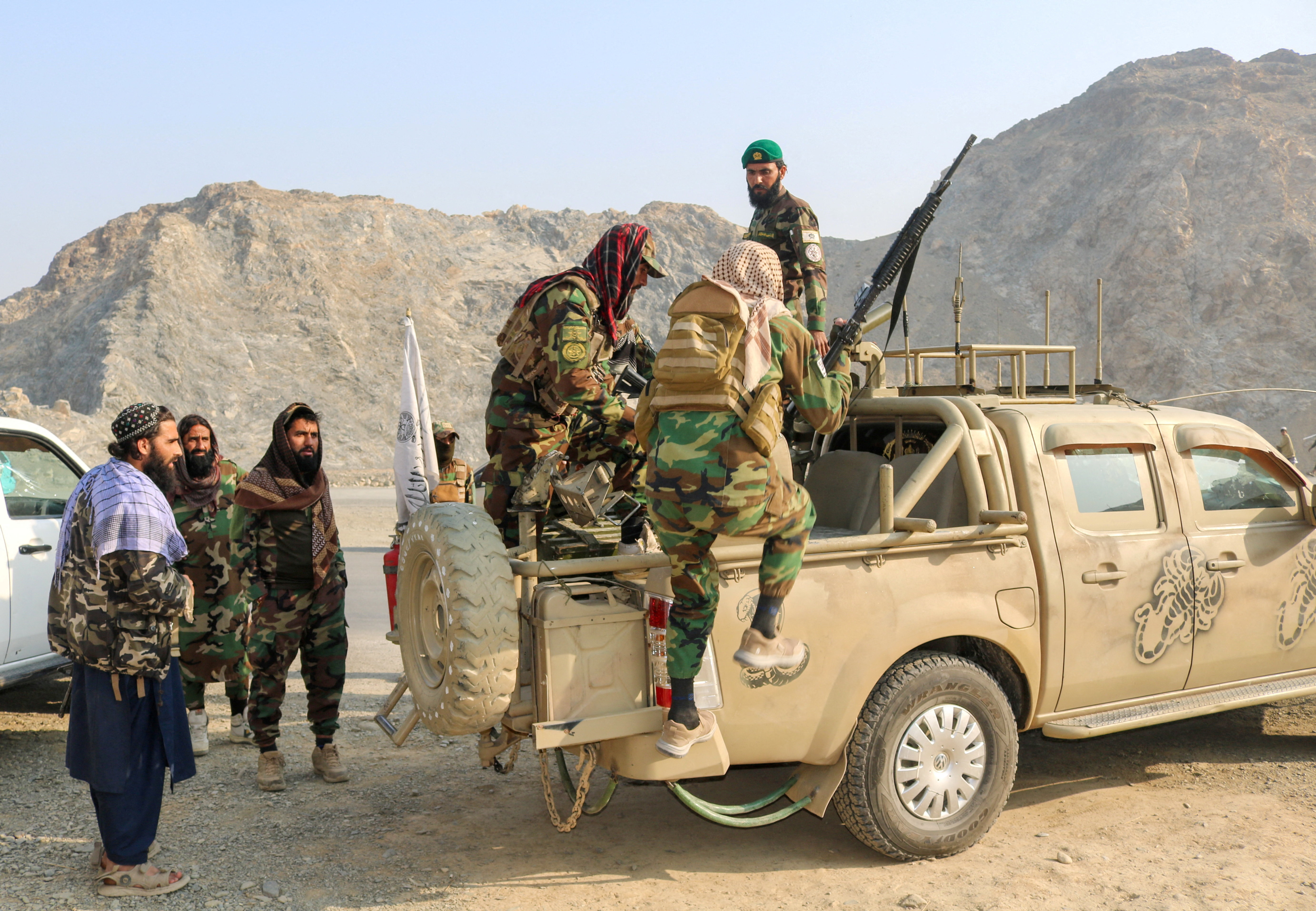 Taliban soldiers carry rocket launcher in a vehicle near Torkham border
