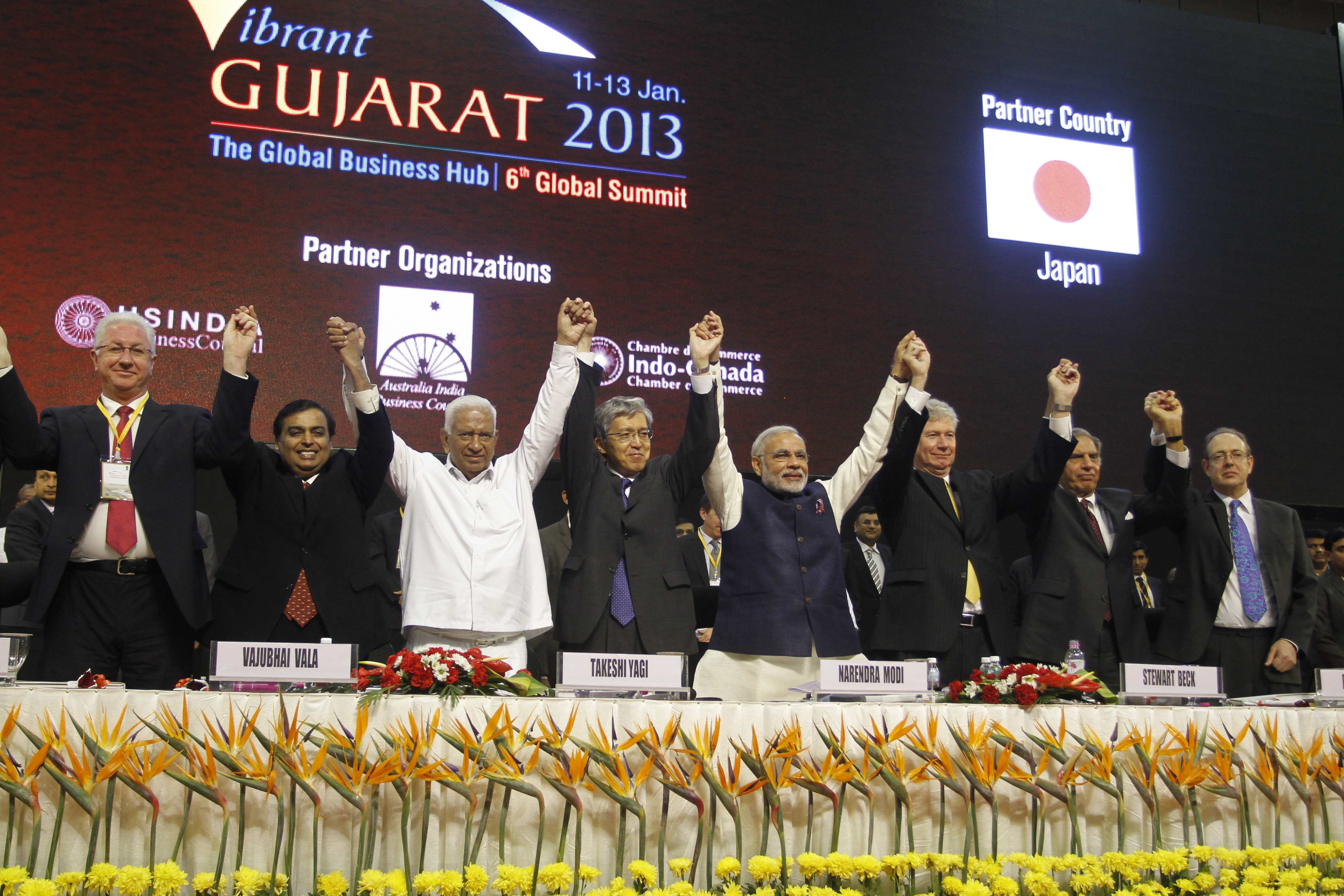 FILE - In this Jan. 11, 2013 file photo, then-Gujarat Chief Minister Narendra Modi, fourth from right, Japanese Ambassador to India Takeshi Yagi, fourth from left, and other participants raise their hands as they pose for photos during the inauguration of the 6th Vibrant Gujarat Global Summit (VGGS) in Gandhinagar, India. Vibrant Gujarat Global Summit is a biennial gathering for discussion and action on emerging business opportunities in Gujarat and beyond. Modi, who is now India's prime minister, will arrive in Japan Saturday, Aug. 30, 2014 for his five-day visit. So far, Japans investments have been concentrated mainly in Indias thriving pharmaceuticals sector and auto industry - Maruti-Suzuki, a subsidiary of Japans Suzuki Motor Corp., is Indias biggest carmaker. Others are: from left, Vice-Governor and Chairman of the Regional Government of Astrakhan of Russian Federation Konstantin Markelov, Reliance Industries Limited Chairman Mukesh Ambani, former Gujarat Finance Minister Vajubhai Vala, Yagi, Modi, Canadian High Commissioner to India Stewart Beck, retired Tata Group Chairman Ratan Tata and British High Commissioner to India James Bevan. (AP Photo/Ajit Solanki, File)