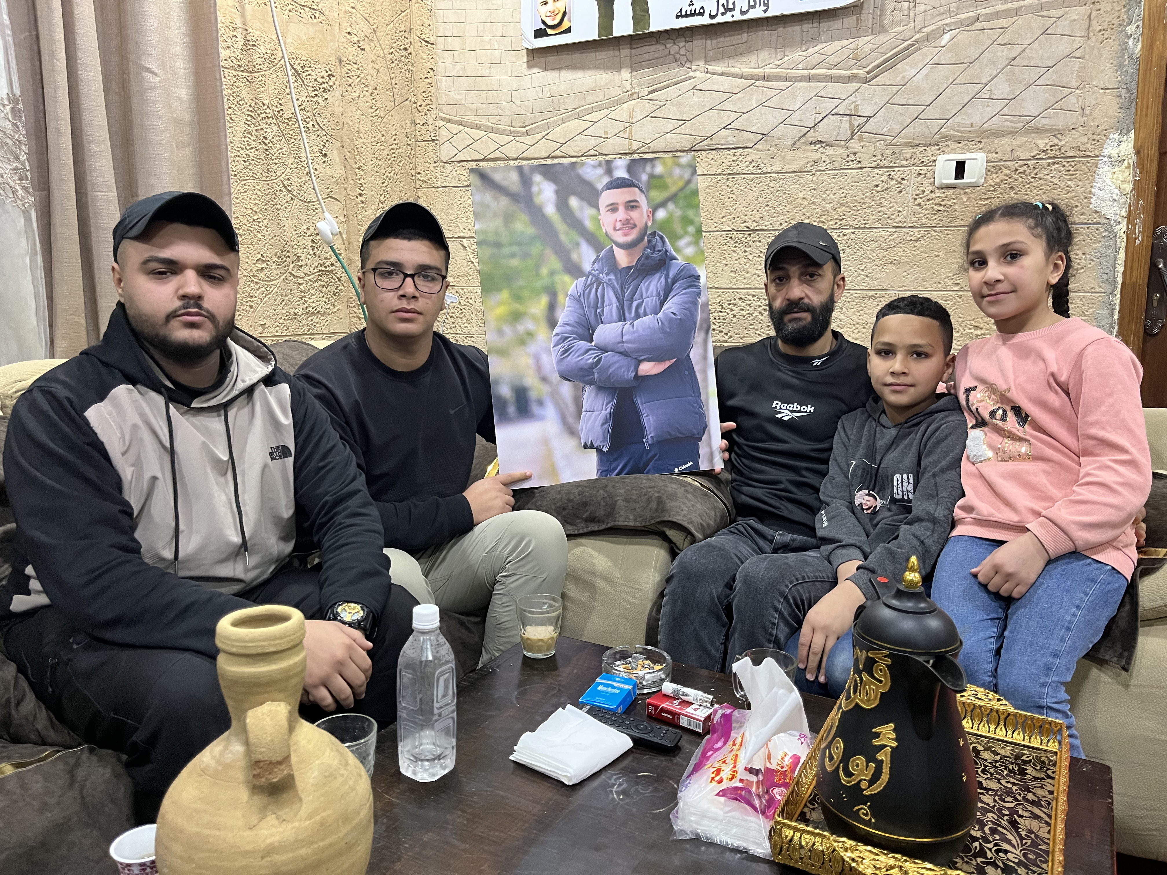 People gathered around a large picture