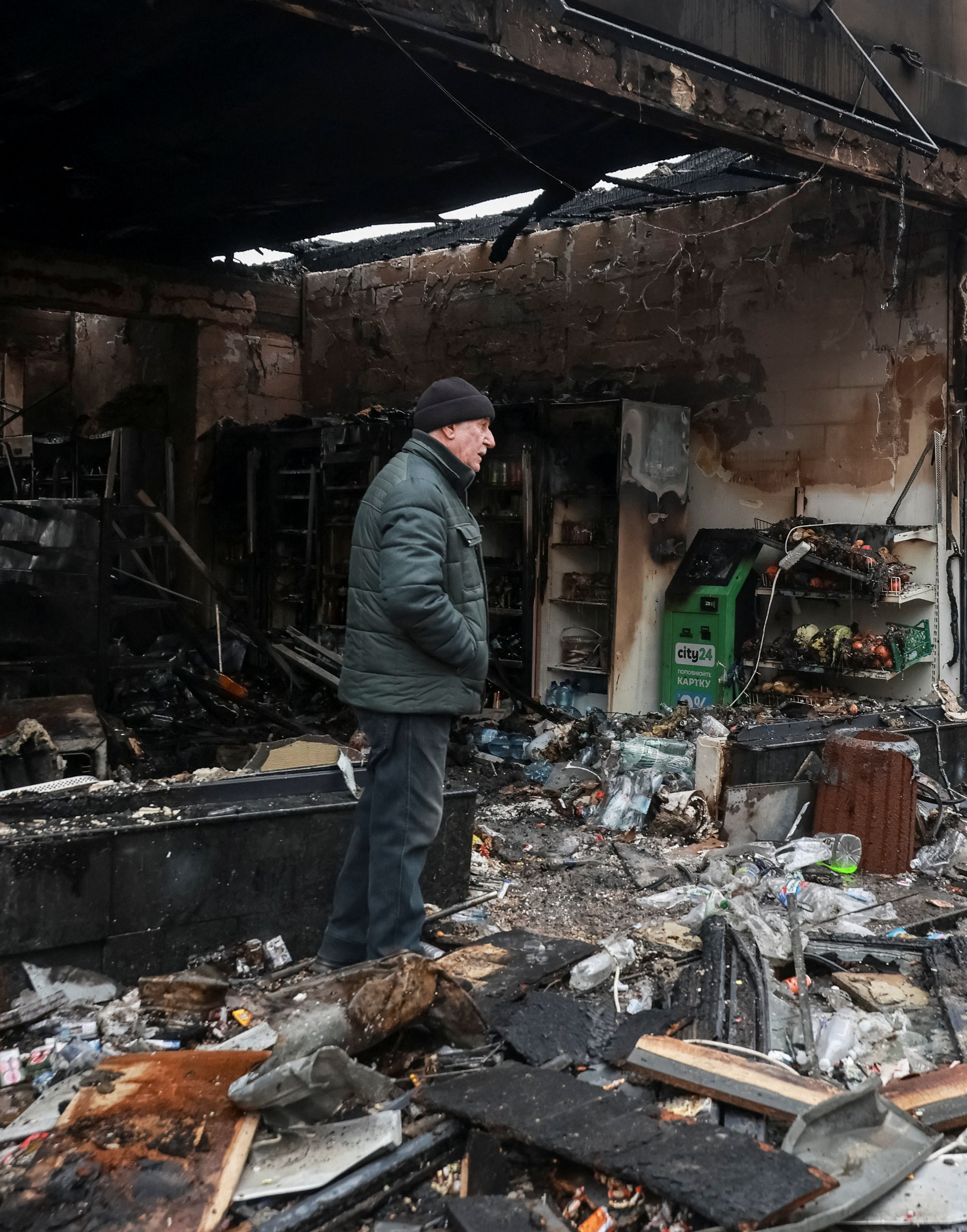 A resident stands at the site of a Russian drone strike, amid Russia's attack on Ukraine, in Odesa, Ukraine, February 17, 2026. REUTERS/Nina Liashonok