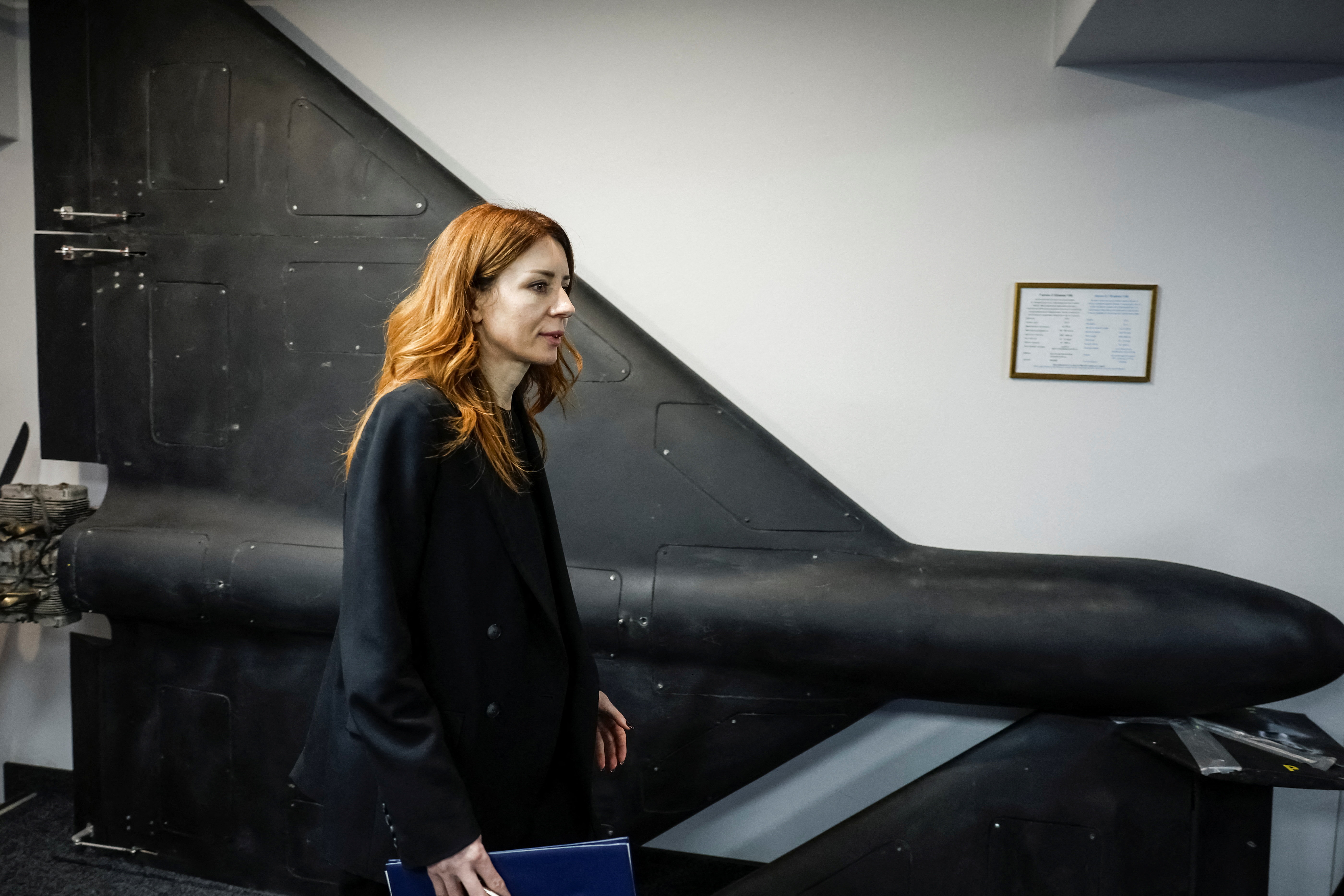 Ukraine's Energy Minister Svitlana Hrynchuk walks by an exhibit of a drone.