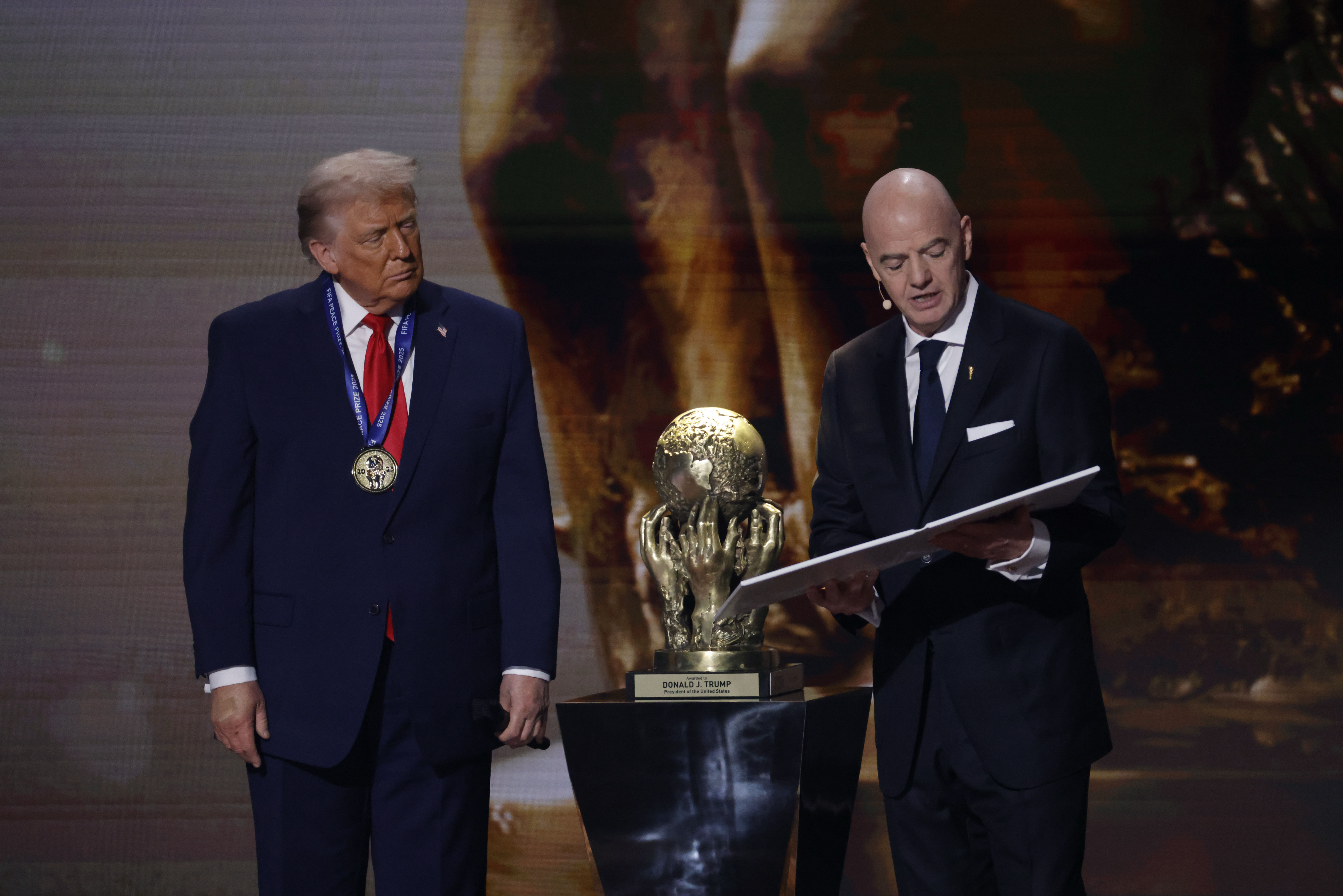 U.S. President Donald Trump (L) receives the FIFA Peace Prize from FIFA President Gianni Infantino (R) during the FIFA World Cup 2026 Final Draw at John F. Kennedy Center for the Performing Arts