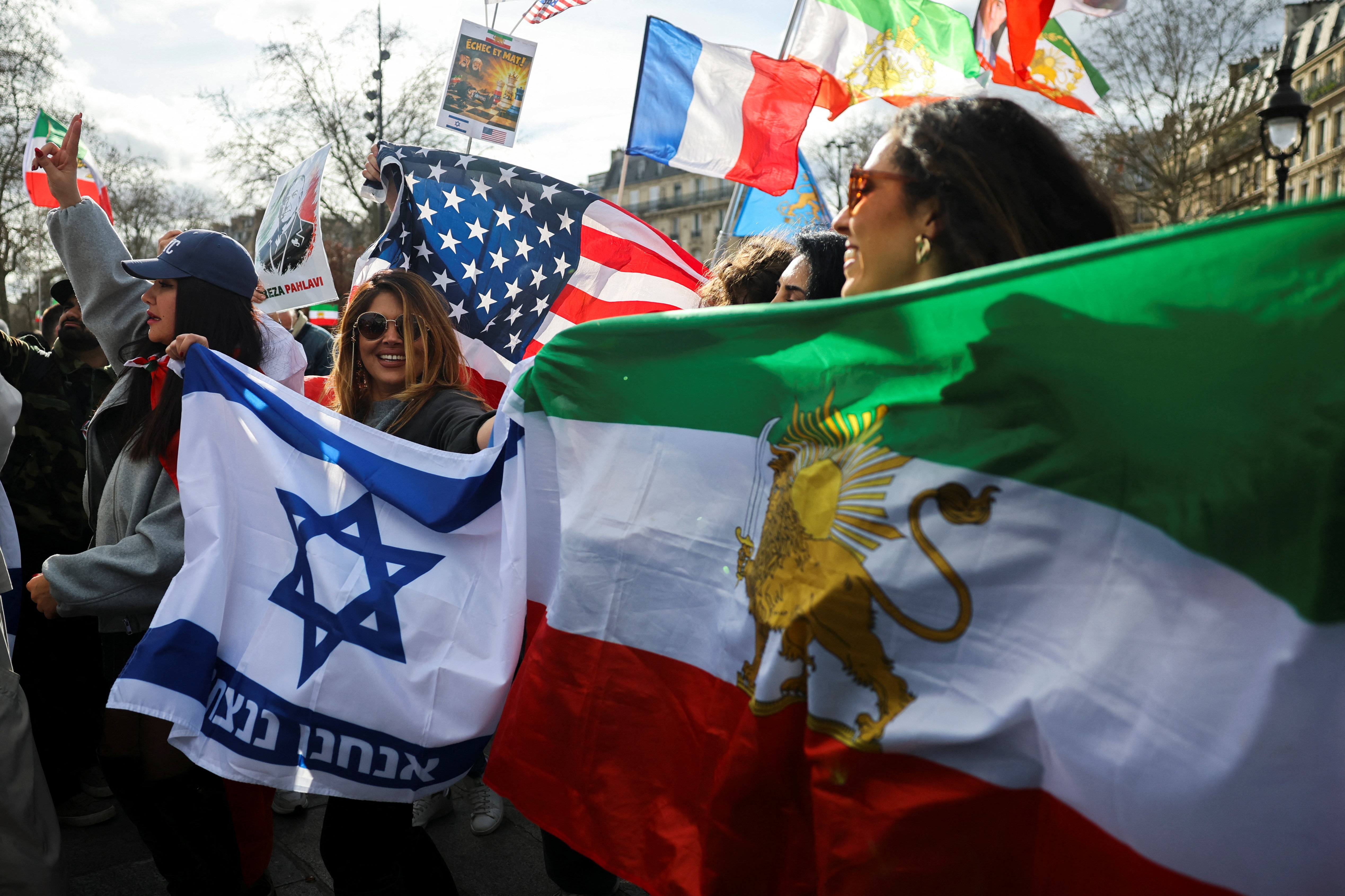 People attend a demonstration with Israeli, American and Iranian flags in support of the Iranian people and to demand the end of the Islamic Republic of Iran after the U.S. and Israel launched strikes on Iran, in Paris, France, March 1, 2026. REUTERS/Sarah Meyssonnier