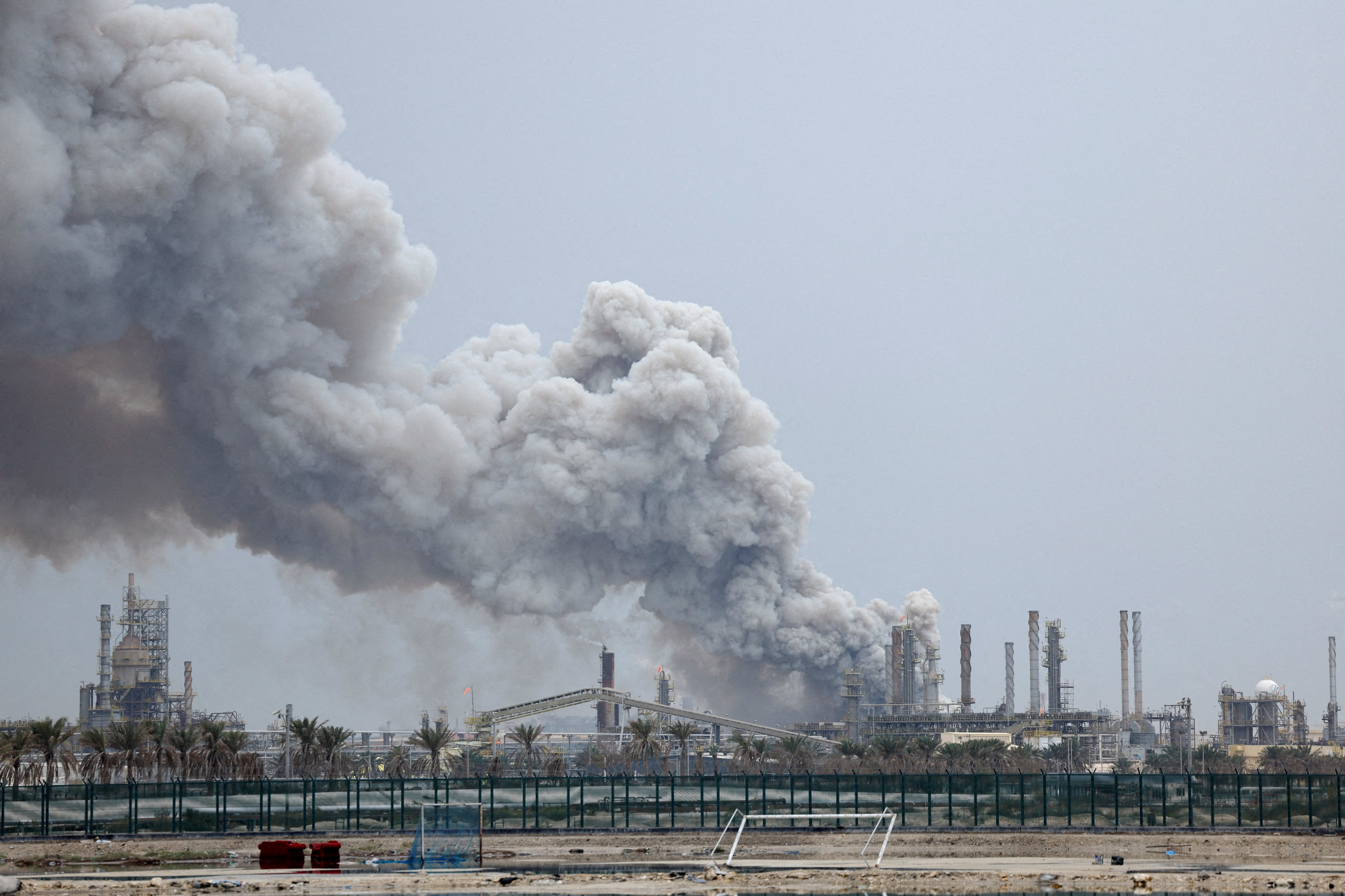 Smoke rises following a strike on an oil refinery.