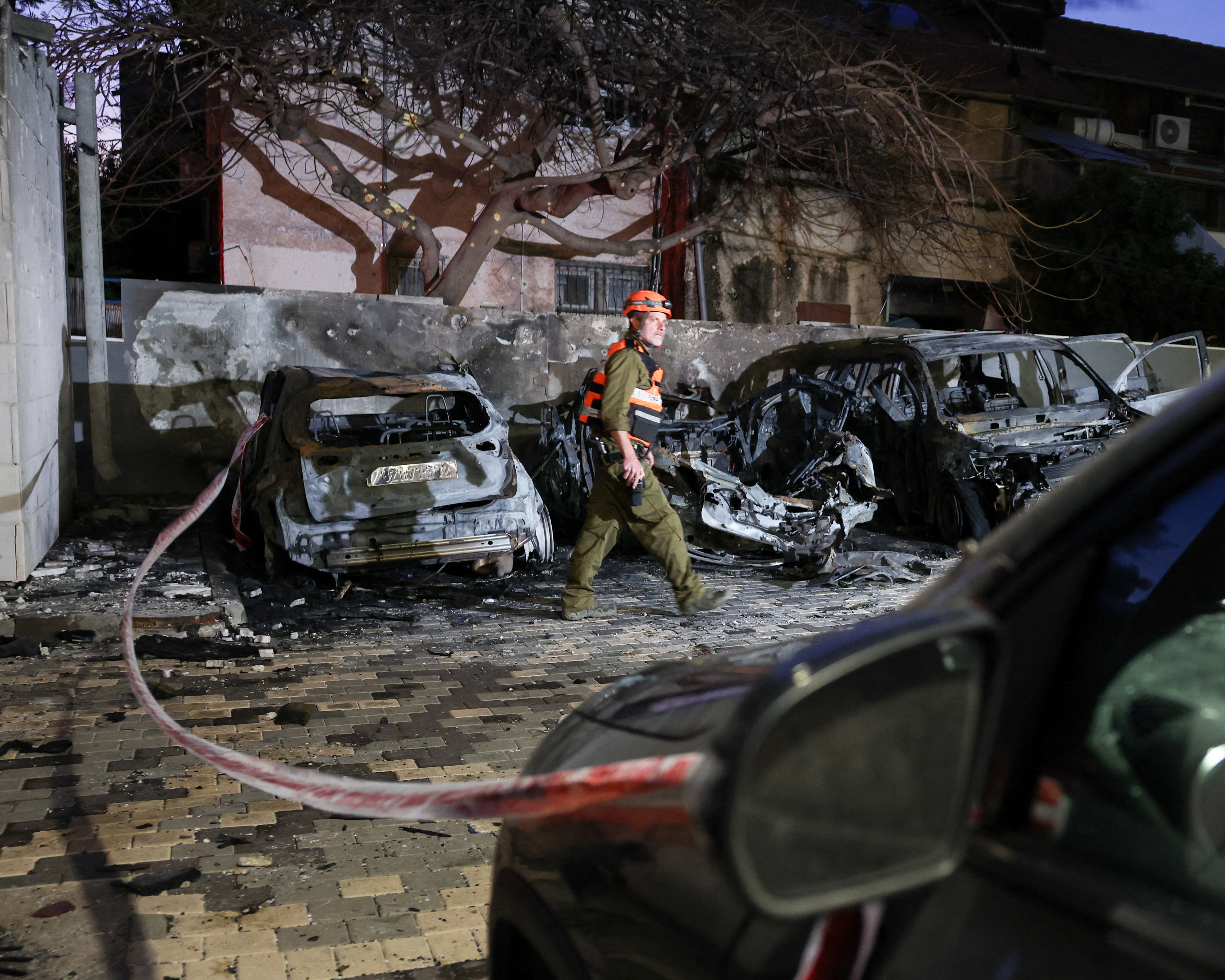 An Israeli soldier inspects the impact site following Iranian missile barrages, amid the U.S.-Israeli conflict with Iran, in Nahariya, Israel, March 26, 2026. [Tyrone Siu/Reuters]