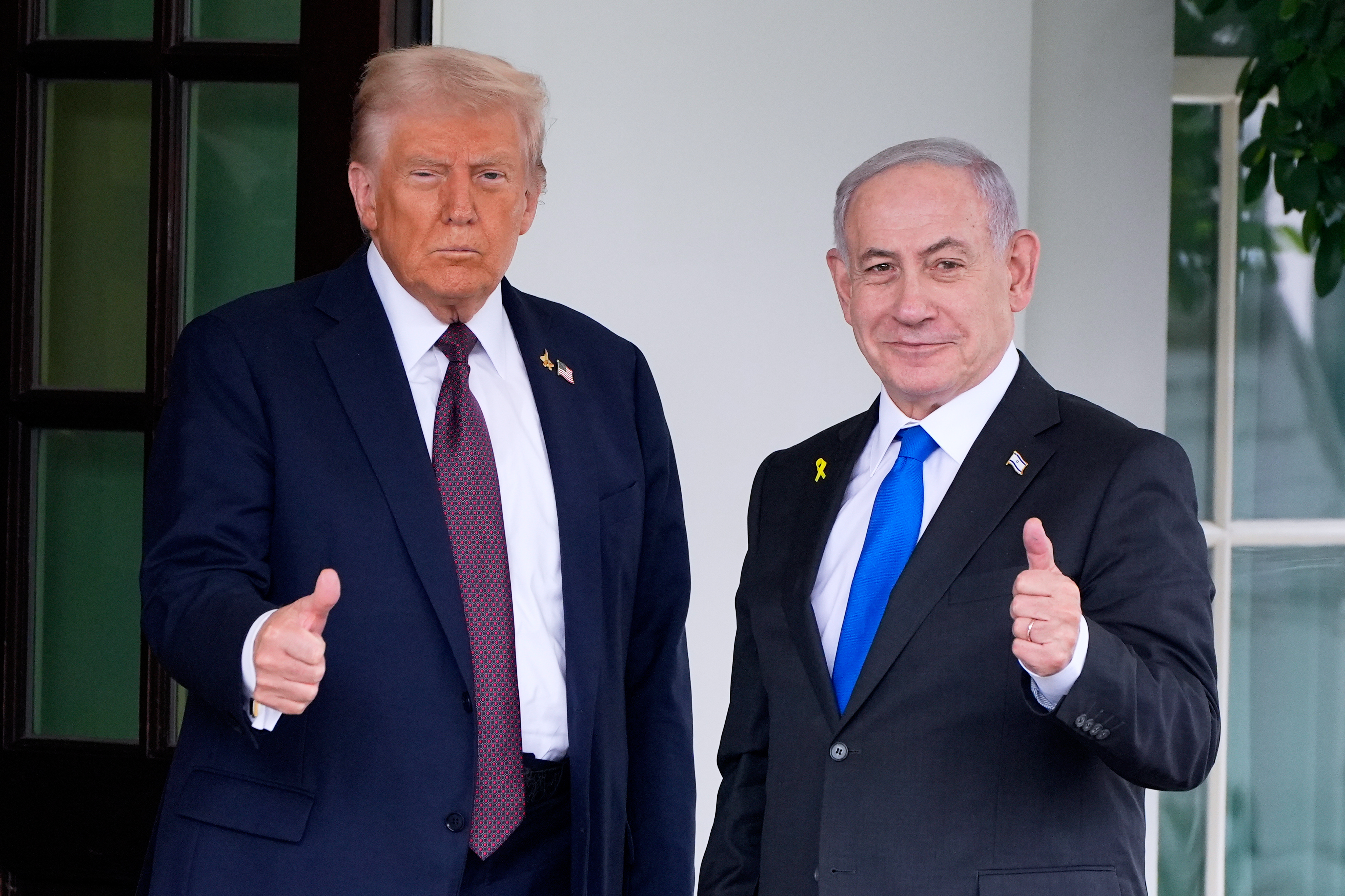President Donald Trump and Israeli Prime Minister Benjamin Netanyahu make thumbs-up signs.