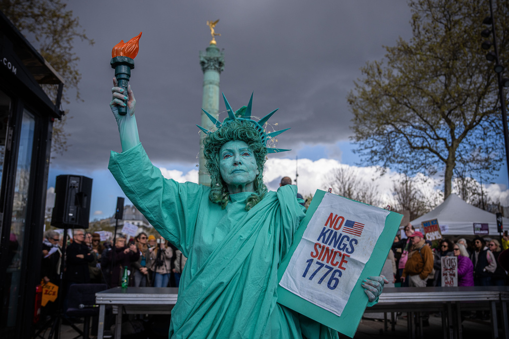 A woman dressed as the Statue of Liberty at an anti-trump protest in Paris