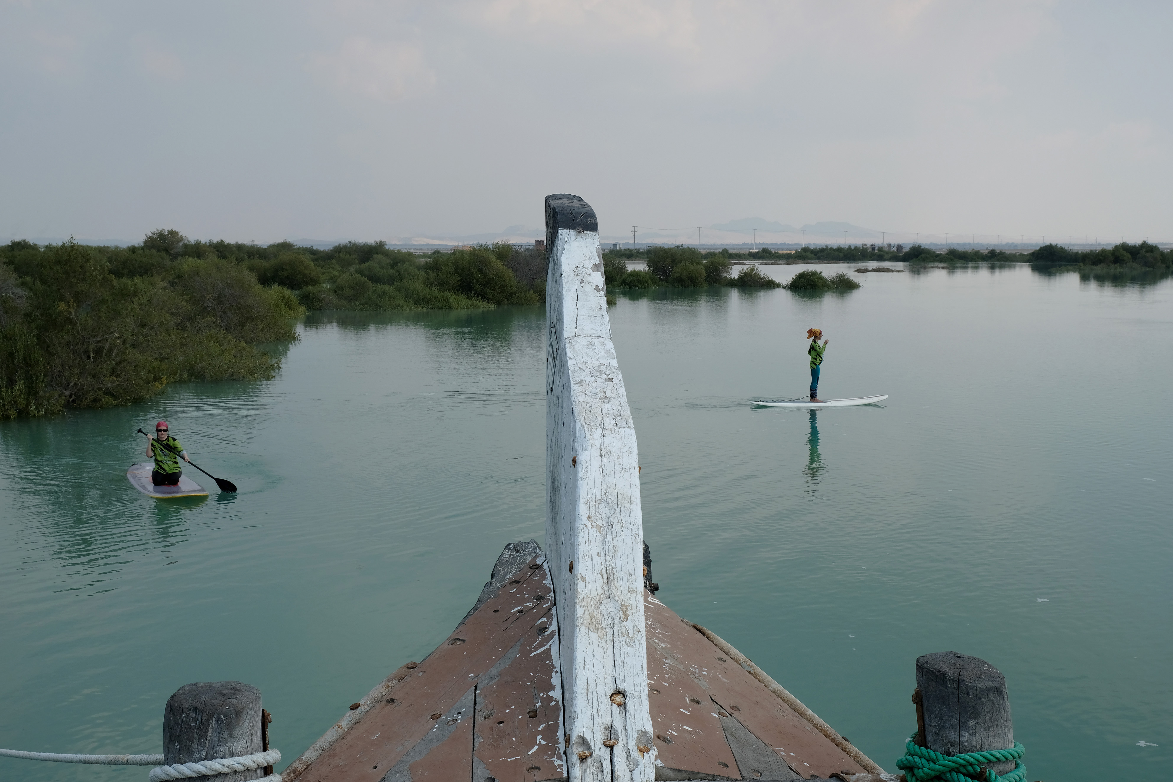 QESHM ISLAND, IRAN - FEBRUARY 28, 2021: Two women on paddling boards dressed in special outfits to observe the Islamic dress code seen relaxing in quiet waters of Hara mangrove forest on February 28, in Qeshm Island, Iran. Iranians choose to travel to the Persian Gulf islands and chill out due to lesser restrictions imposed by the government. (Photo by Kaveh Kazemi/Getty Images)