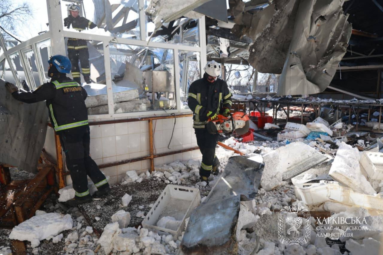 Ukrainian rescuers clear debris following a Russian attack in Kharkiv