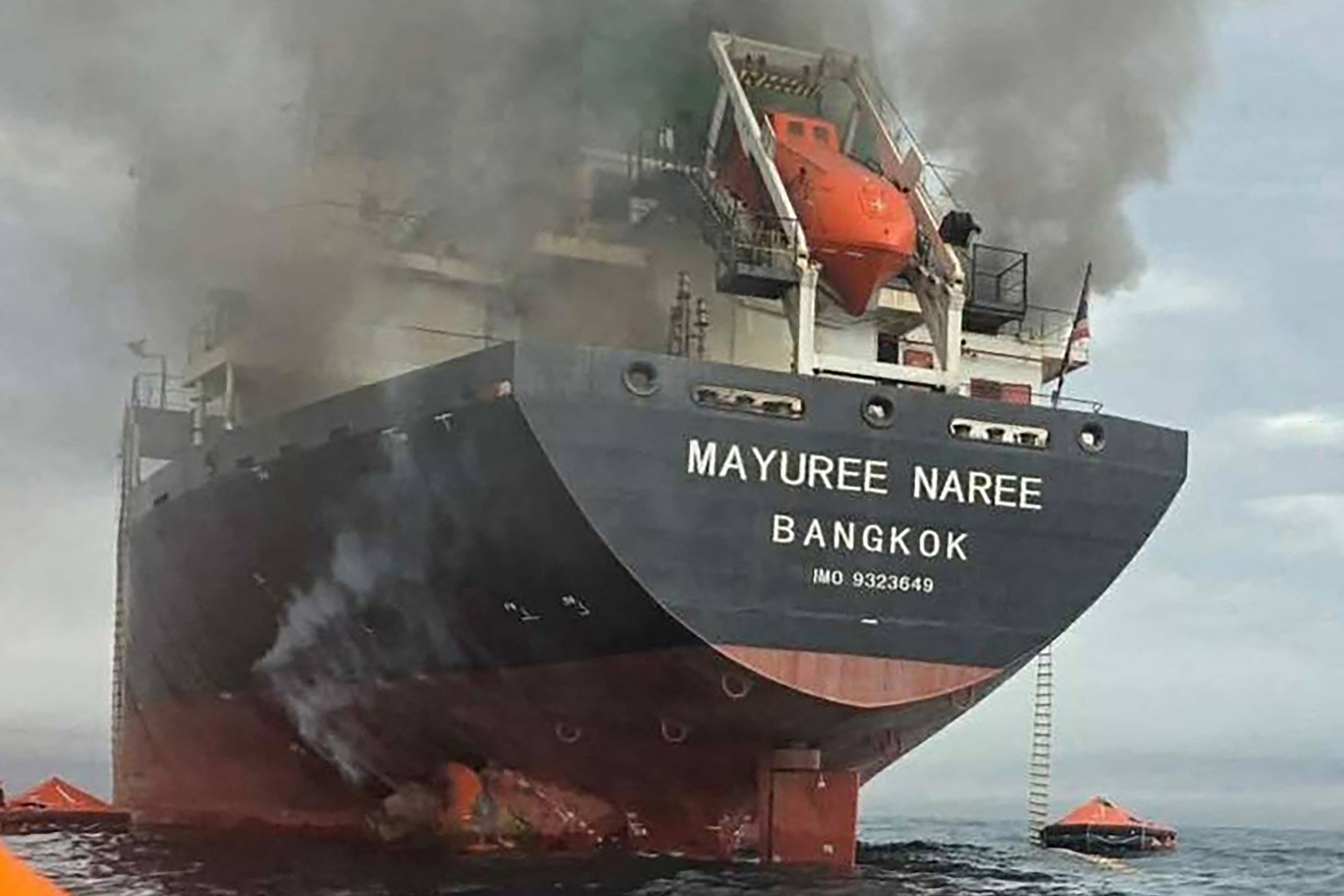 TOPSHOT - This handout photo taken on March 11, 2026 and released by the Royal Thai Navy shows smoke rising from the Thai bulk carrier 'Mayuree Naree' near the Strait of Hormuz after an attack.