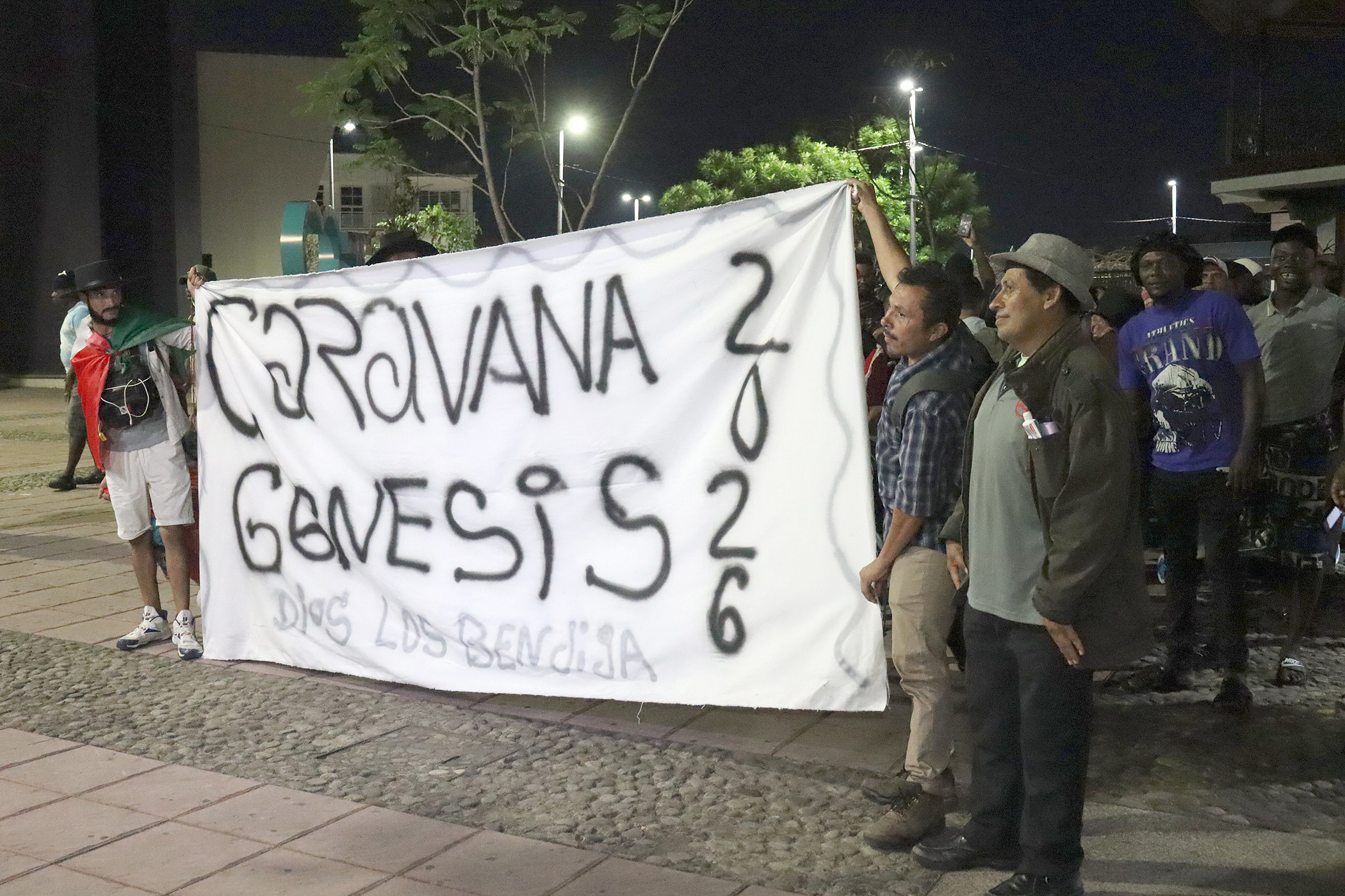 epa12849756 Migrants hold a sign reading 'Caravana Genesis 2026' (Genesis Caravan 2026) as they depart in a caravan in Tapachula, Mexico, 25 March 2026. The caravan, composed mainly of migrants from Caribbean and Central American countries, was named by migrants 'Genesis 2026'. EPA/JUAN MANUEL BLANCO