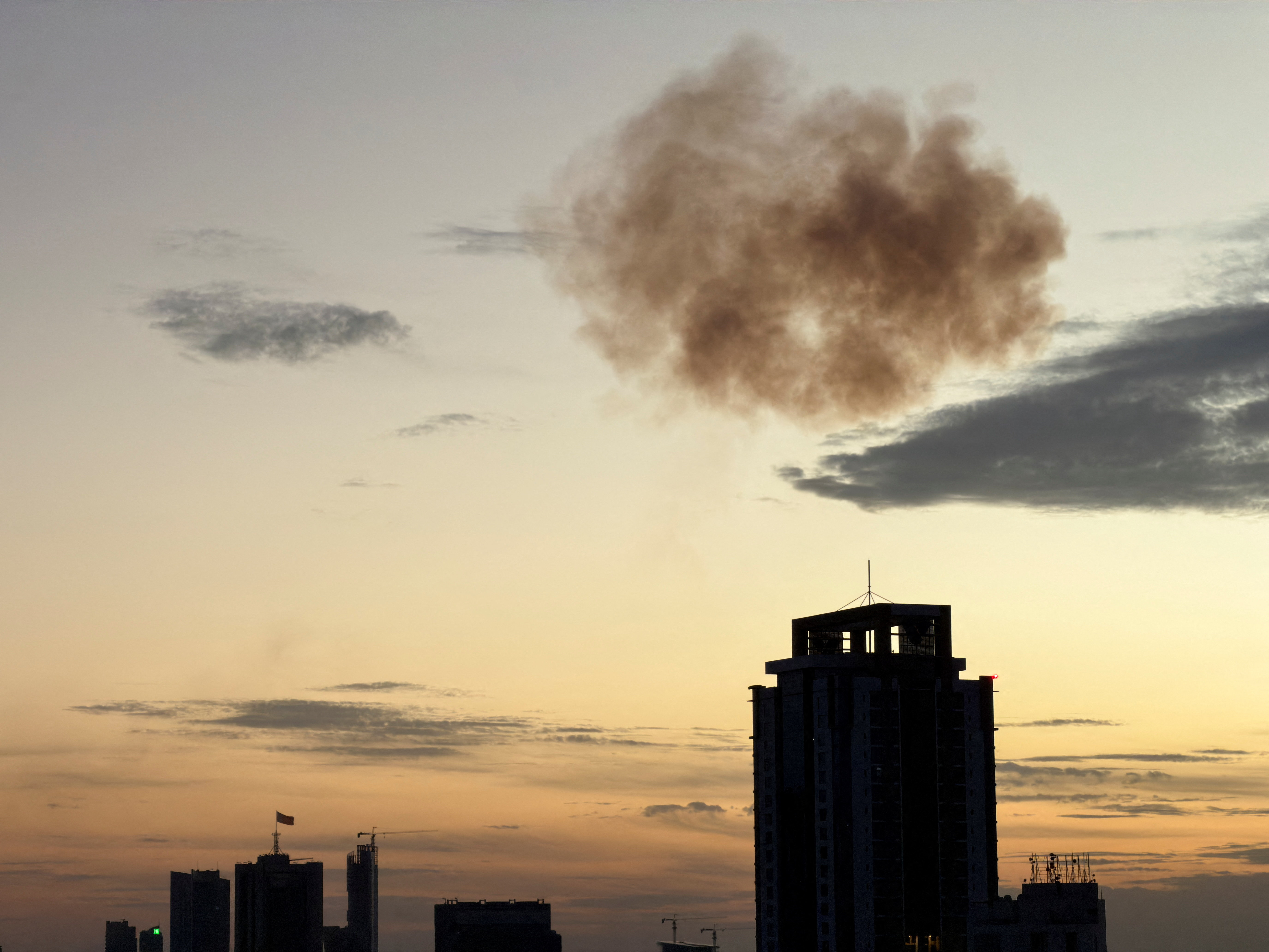 Smoke rises after an Iranian drone was intercepted in Manama, Bahrain