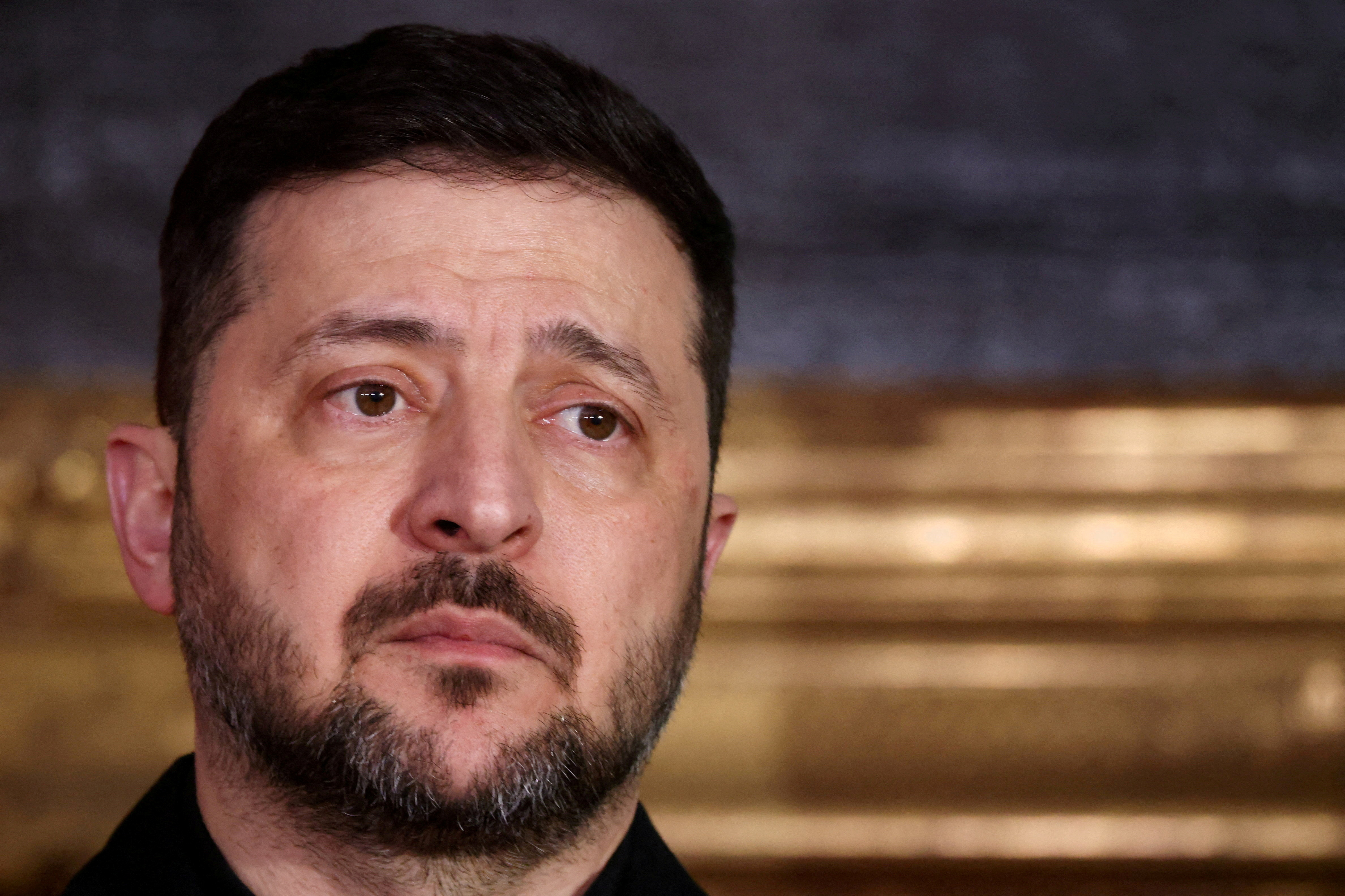 FILE PHOTO: Ukrainian President Volodymyr Zelenskiy looks on as he delivers a statement along with Bavarian federal state prime minister Markus Soeder (not pictured), chairman of the Munich Security Conference Wolfgang Ischinger (not pictured), Polish Prime Minister Donald Tusk (not pictured) during the Munich Security Conference MSC, at the Residenz of the former Bavarian Kings, in Munich, Germany, February 14, 2026. REUTERS/Liesa Johannssen/File Photo