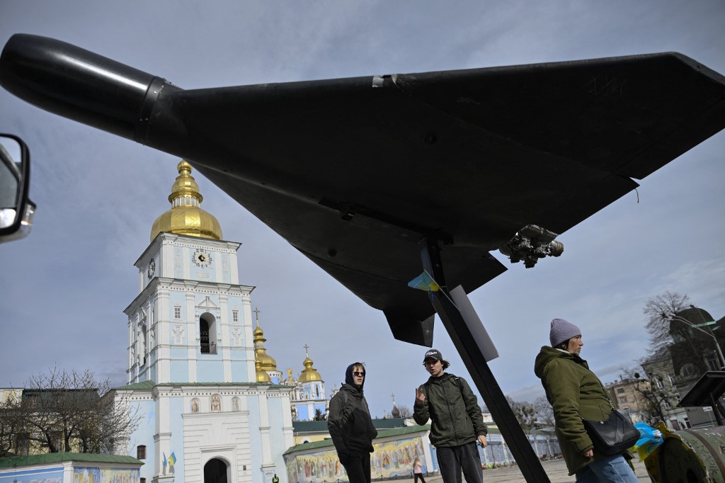 People look at an Iranian-designed HESA Shahed 136 (Geran-2) drone at an open-air exhibition of destroyed Russian military equipment on Mykhailivska Square in front of Saint Michael's Golden-Domed Cathedral, in Kyiv, on April 7, 2026, amid the Russian invasion of Ukraine. (Photo by Genya SAVILOV / AFP)
