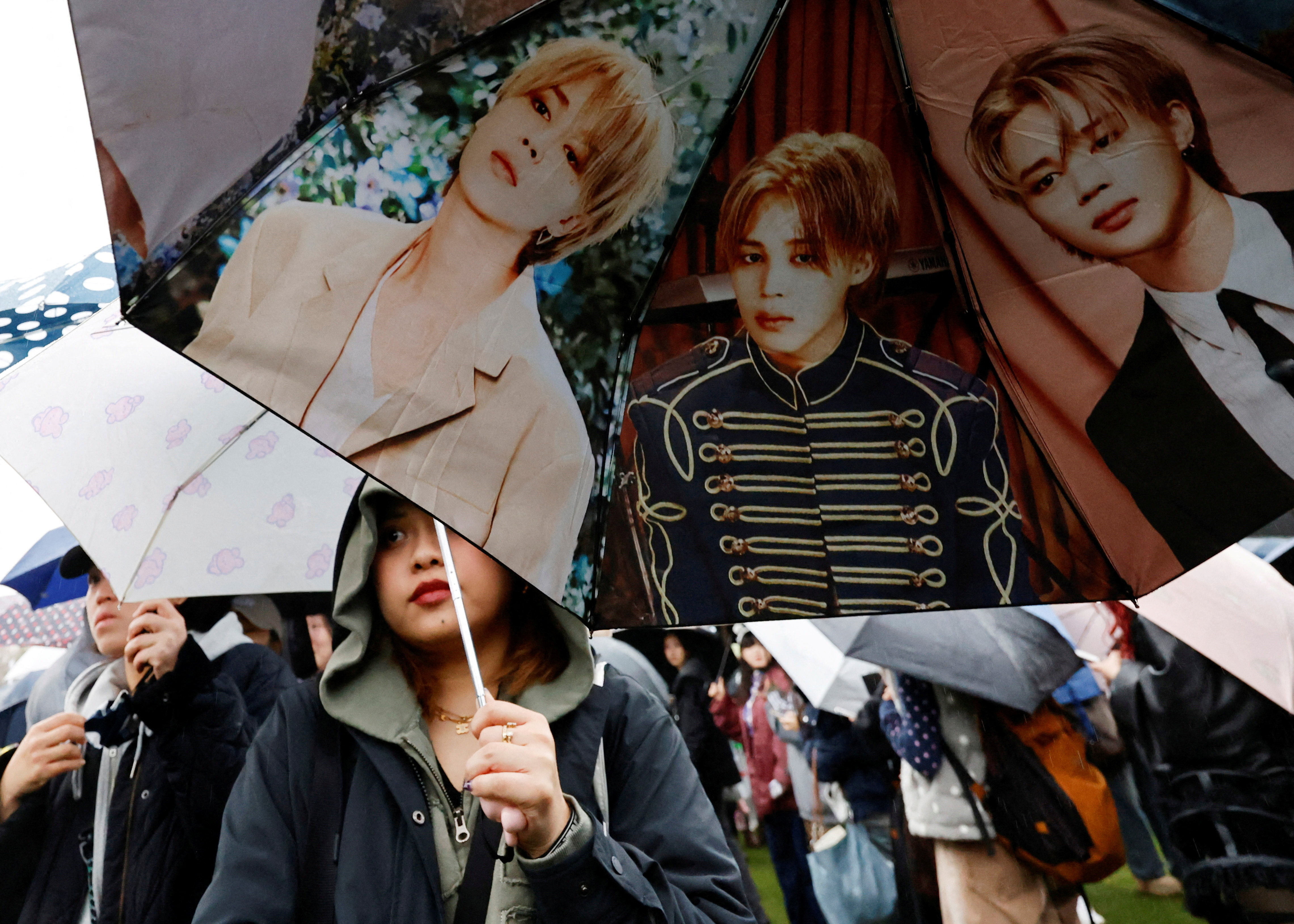 An umbrella with K-pop boy band BTS member Jimin's images as fans of BTS, known as ARMY, wait in line to enter the concert venue, ahead of the band's first world‑tour concert "ARIRANG" in more than three years, at Goyang stadium in Goyang, South Korea, April 9, 2026. REUTERS/Kim Soo-hyeon TPX IMAGES OF THE DAY