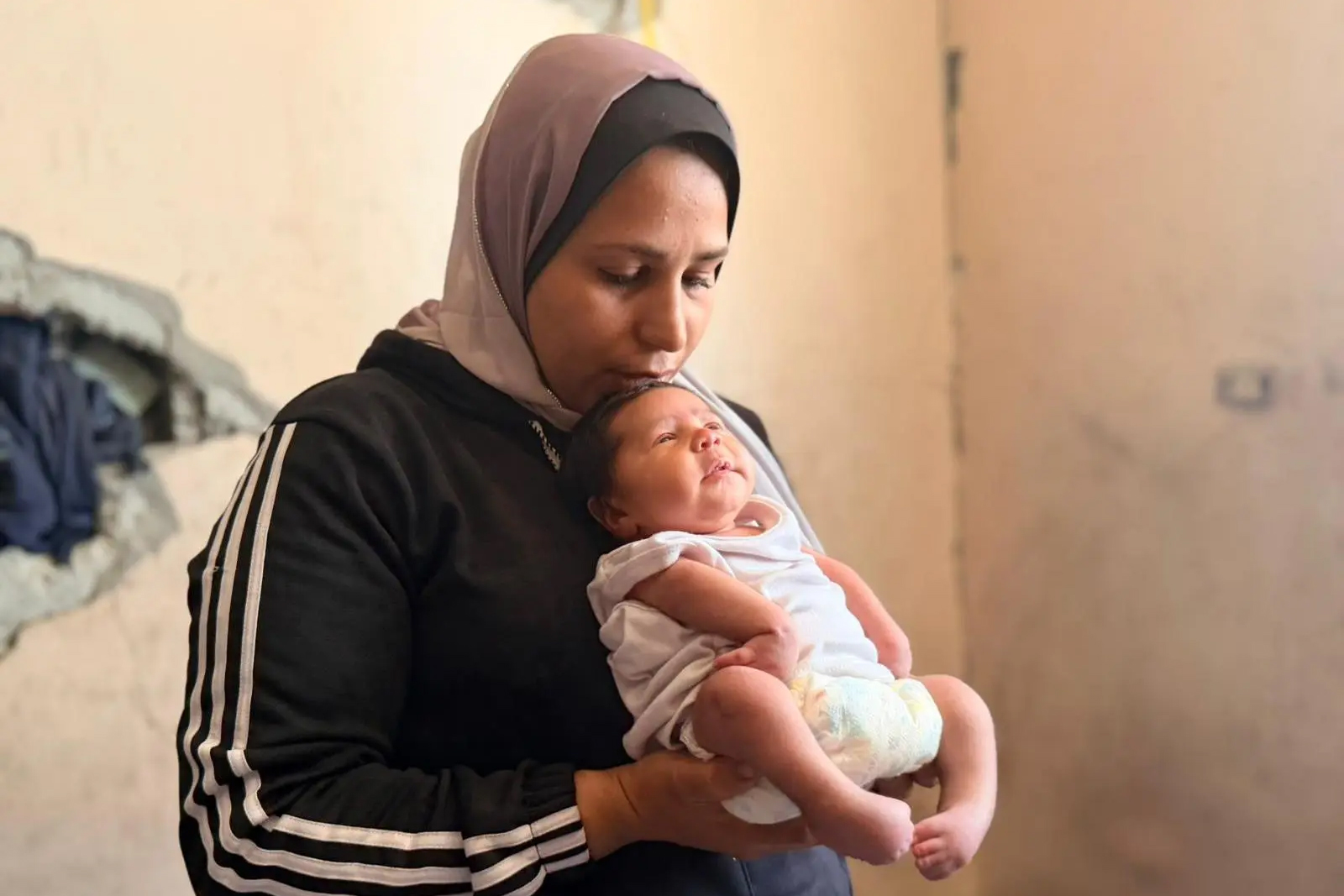 Warda al-Jarou holds her six-month-old daughter, Misk. The infant was born with severe deformities after her mother was repeatedly exposed to toxic gas and bombardment during pregnancy.