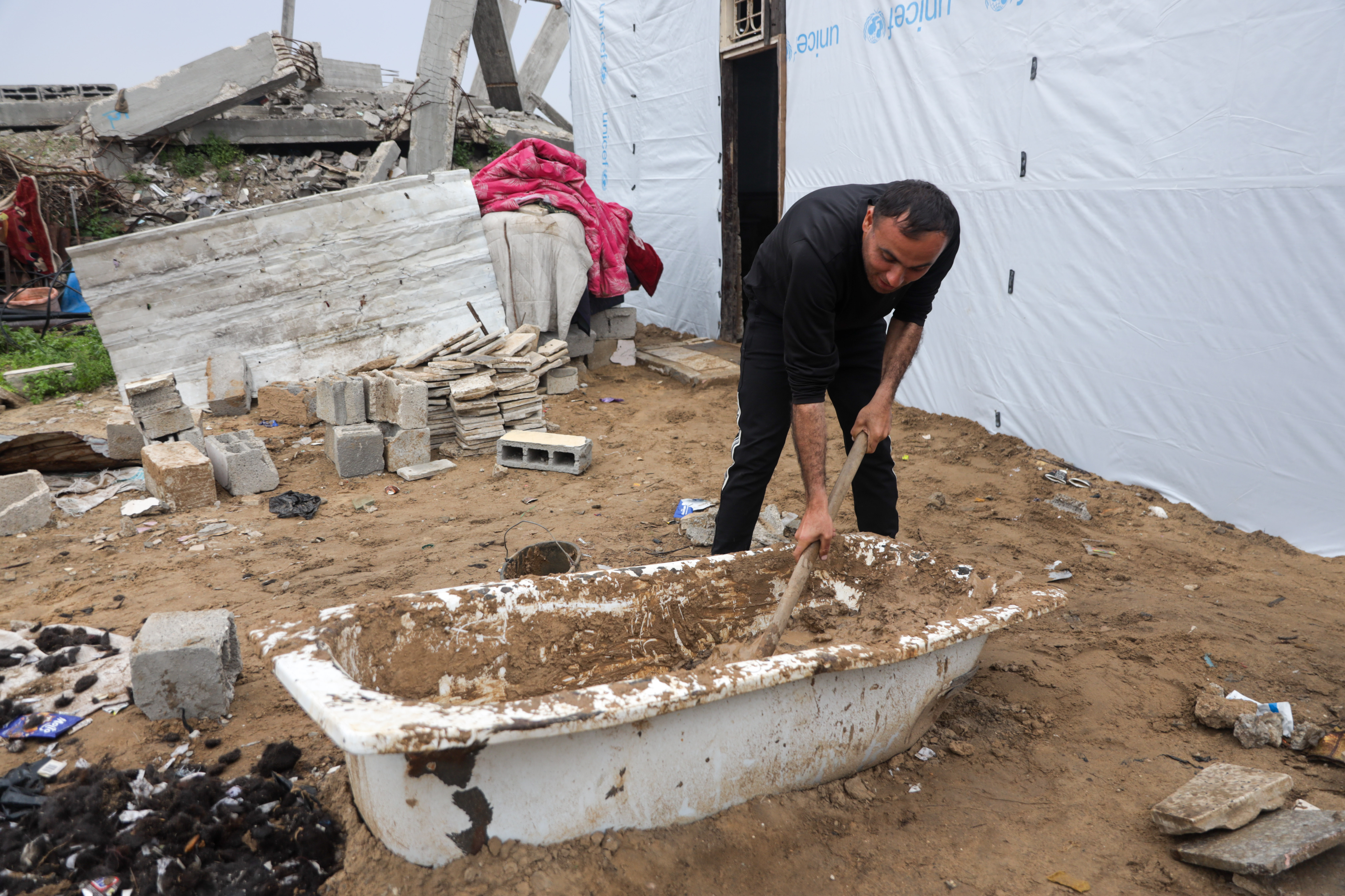 Mohammed al-Jadba mixes hair with mud to make it stronger – the straw that is normally used for the task is unavailable in Gaza
