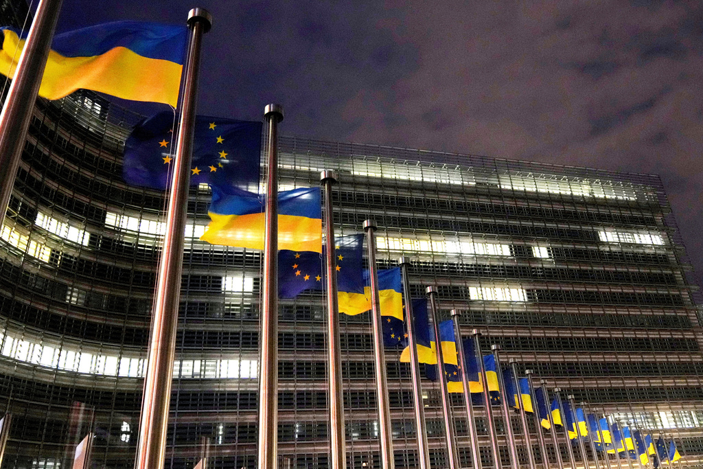 The European Union and Ukrainian flags flap in the wind